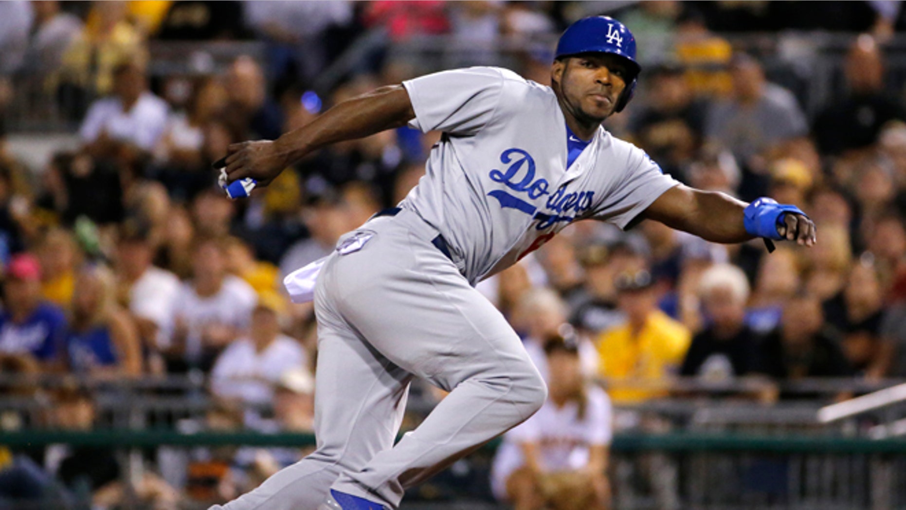 FILE - In this July 23, 2014, file photo, Los Angeles Dodgers' Yasiel Puig leads off first during a baseball game against the Pittsburgh Pirates in Pittsburgh. Twenty-five Cuban-born players appeared in the major leagues this year, a group that includes outfielders Puig and Yoenys Cespedes, and hard-throwing reliever Aroldis Chapman. Fred Claire can see the day when Major League Baseball teams open academies for prospects in Cuba. "It's absolutely a natural, just as the Dominican was and Venezuela. You go to where the talent is," the former Los Angeles Dodgers general manager said Wednesday, Dec. 17, 2014. "The high talent level for Cuban players is still there." (AP Photo/File)