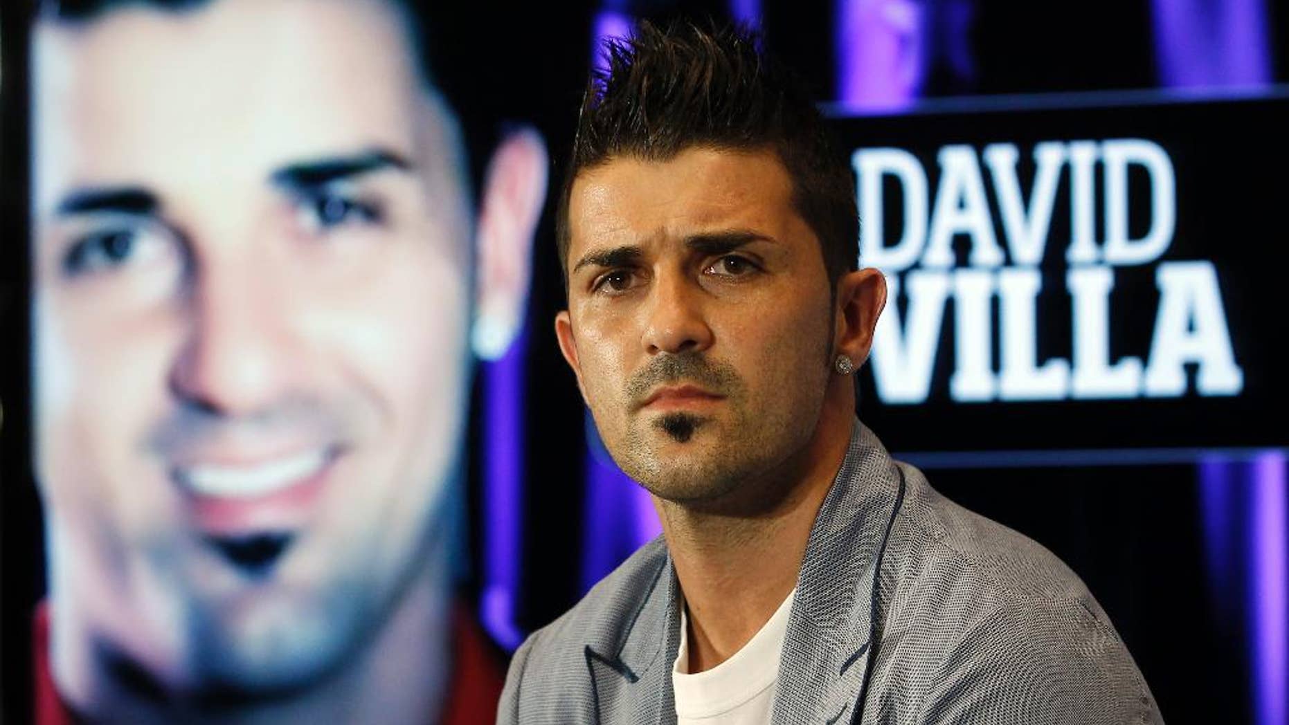 FILE - This is a July 15, 2013 file photo showing Atletico de Madrid's soccer player David Villa during his presentation at the Vicente Calderon Stadium in Madrid. Villa has signed a three-year contract with New York City FC, becoming the first player on the expansion Major League Soccer team that starts play next season. (AP Photo/Andres Kudacki, File)
