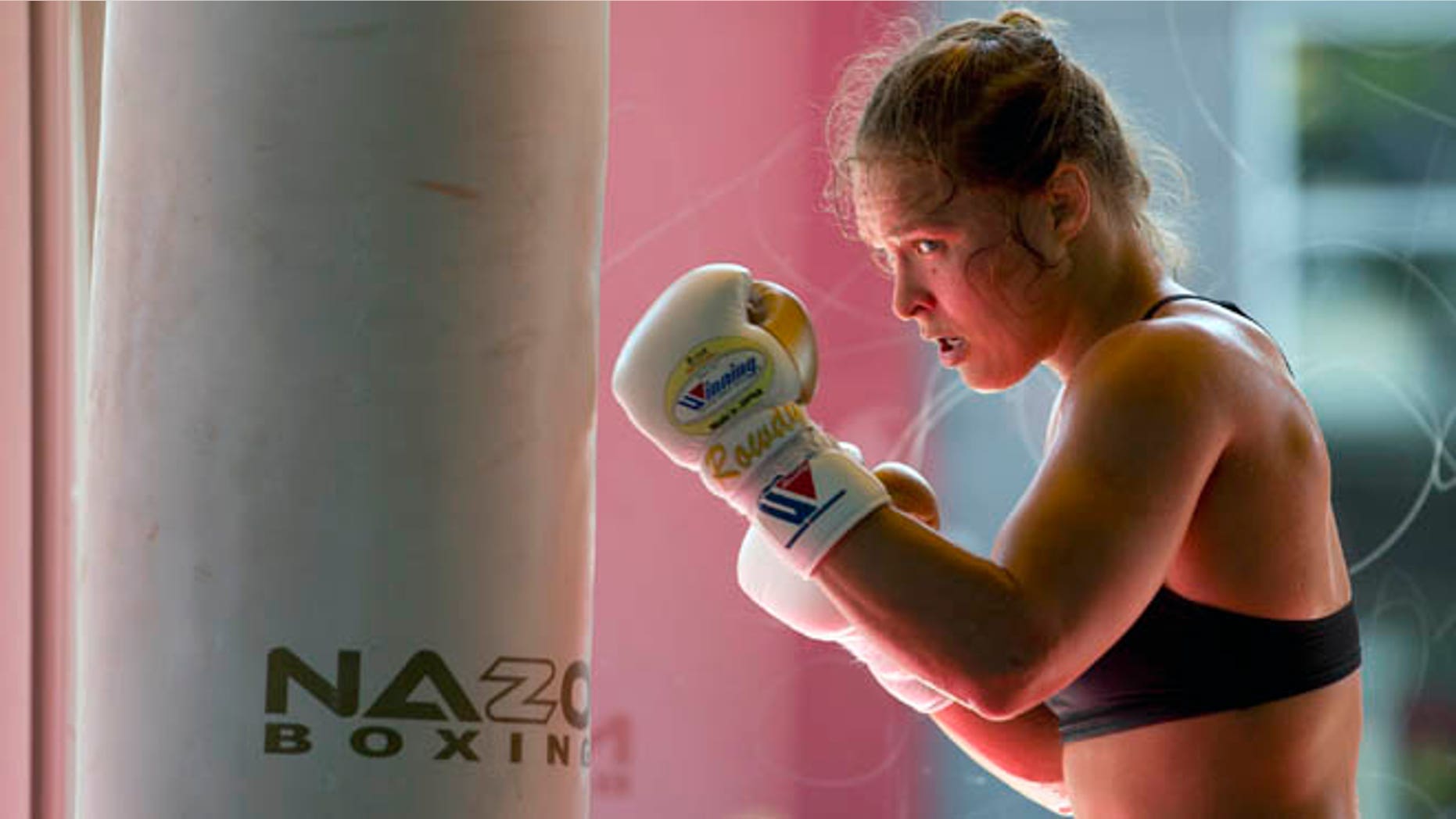 FILE - This July 15, 2015, file photo shows mixed martial arts fighter Ronda Rousey working out at Glendale Fighting Club in Glendale, Calif. Rousey's star power grows with each month, and the UFC's dominant bantamweight champion could have held her next title defense anywhere. She chose to travel to Bethe Correia's native Brazil for UFC 190 on Saturday, Aug. 1, just so she can embarrass the challenger in front of her home fans. (AP Photo/Jae C. Hong,File)