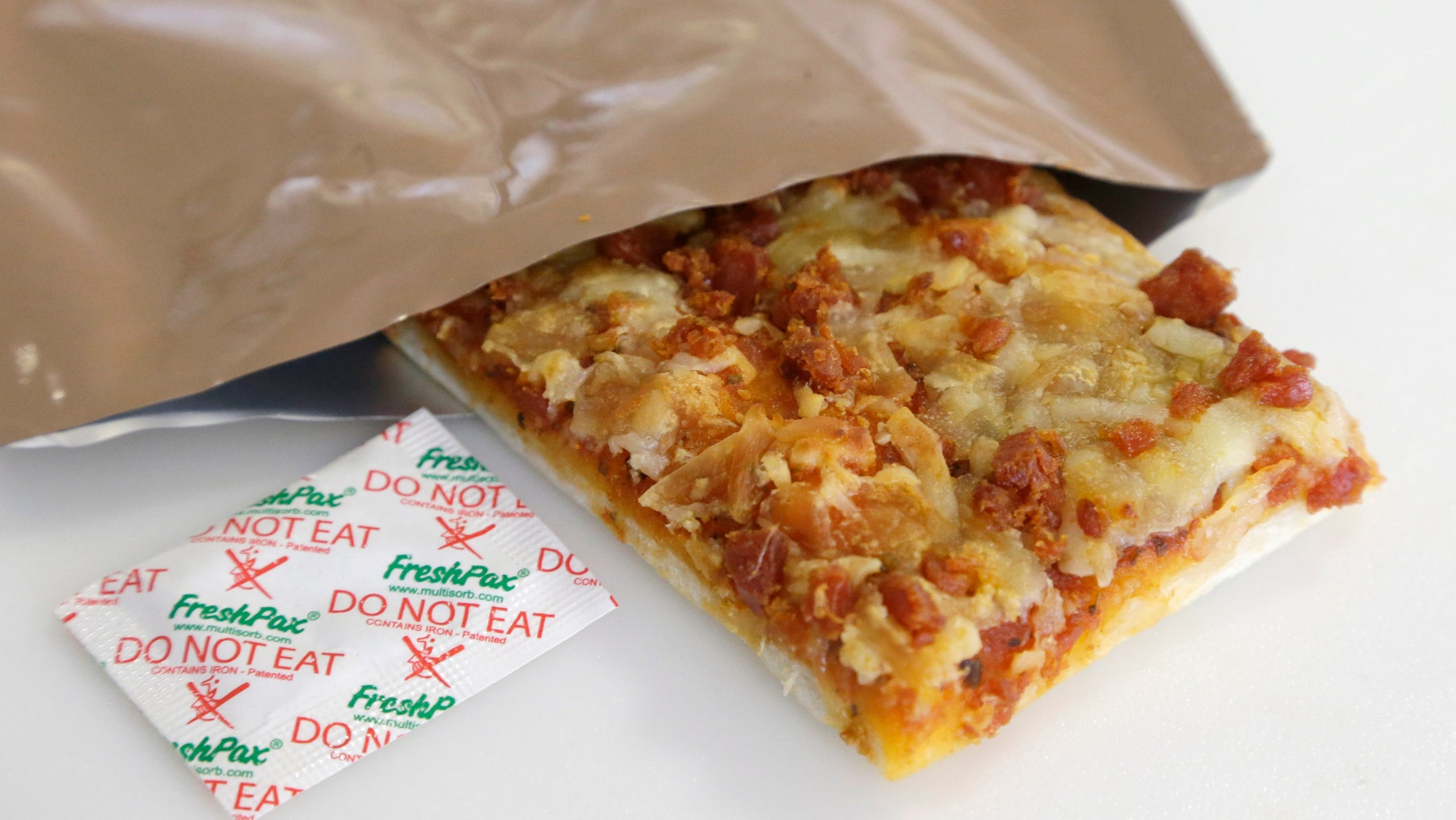 Feb. 6, 2014: A slice of prototype pizza, in development to be used in MRE's -- meals ready to eat -- sits in a packet next to a smaller packet known as an oxygen scavenger, left, at the U.S. Army Natick Soldier Research, Development and Engineering Center in Natick, Mass. Pizza is in development to be used in individual field rations known as meal ready to eat, or MREs. It has been one of the most requested options for soldiers craving a slice of normalcy in the battlefield and disaster areas. (AP/Steven Senne)
