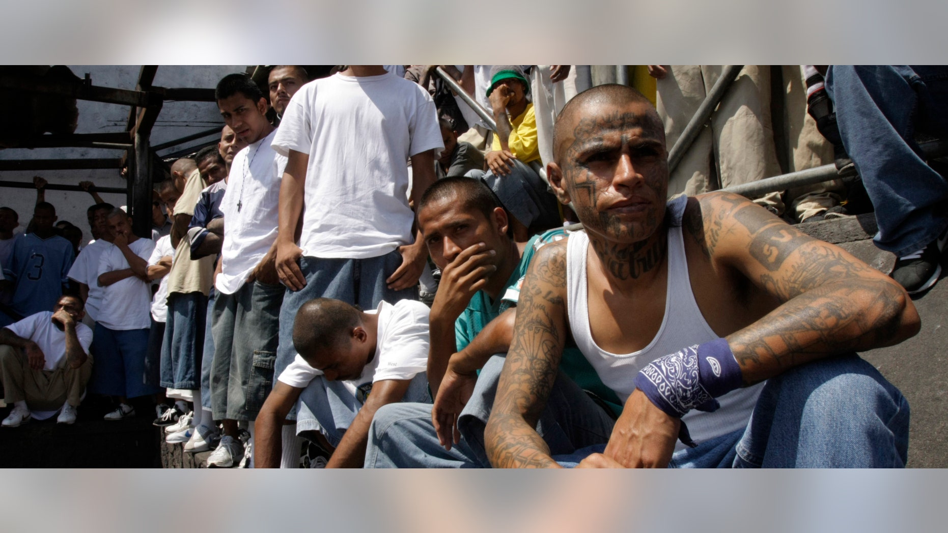 Mara Salvatrucha gang members attend a mass celebrated by Archbishop Luigi Pezzuto, Apostolic Nuncio to El Salvador, and head army and police chaplain Monsignor Fabio Colindres at a prison in Ciudad Barrios, El Salvador, Monday, March 26, 2012. According to Dionisio Aristides Umanzor, known as El Sirra, leader of the Mara Salvatrucha gang, leaders of the Mara Salvatrucha and the Mara 18, El Salvador's two largest street gangs, have reached a truce, reducing the country's homicide rate, one of the highest in the world. (AP Photo/Luis Romero)