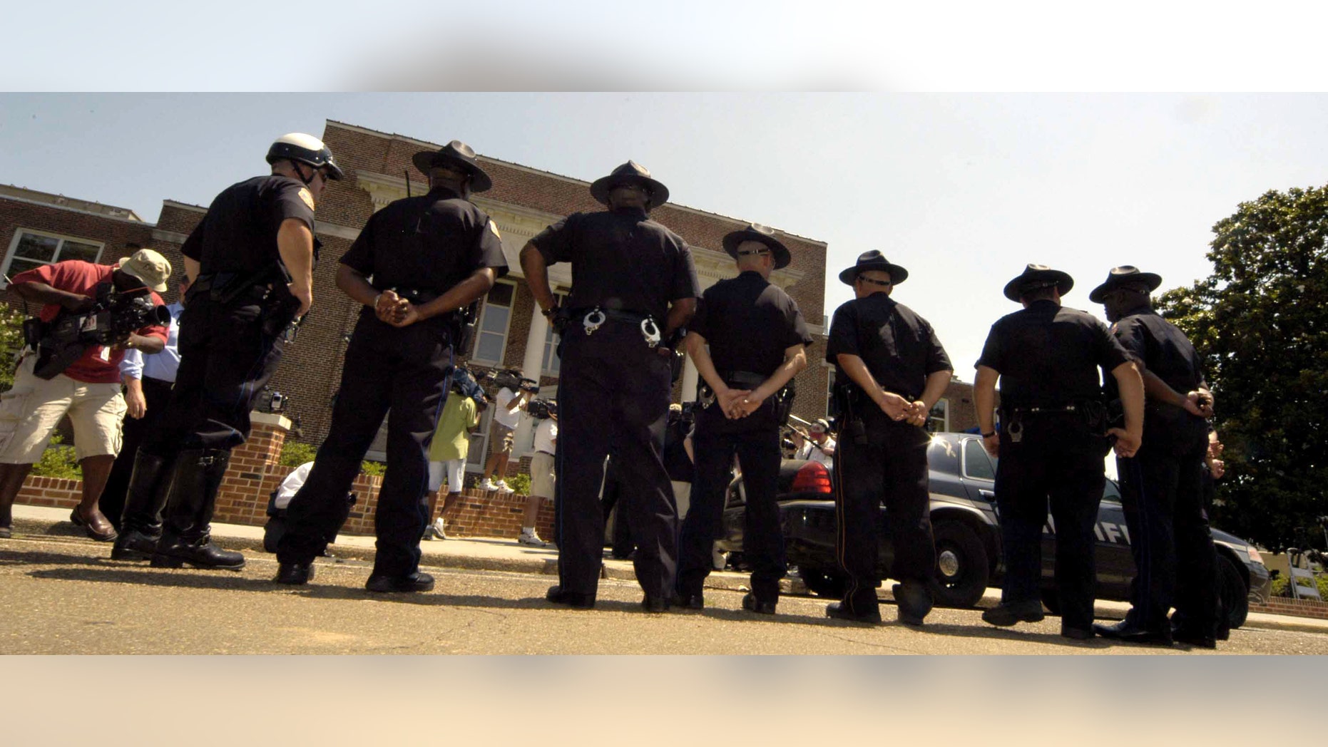 PHILADELPHIA, MS - Philadelphia police stand guard outside the Neshoba County Courthouse during the trial of Edgar Ray Killen on June 15, 2005 in Philadelphia, Mississippi. Killen is accused in the 1964 slayings of civil rights workers James Chaney, Andrew Goodman and Michael Schwerner in a case that came to be known as "Mississippi Burning." (Photo by Marianne Todd/Getty Images)