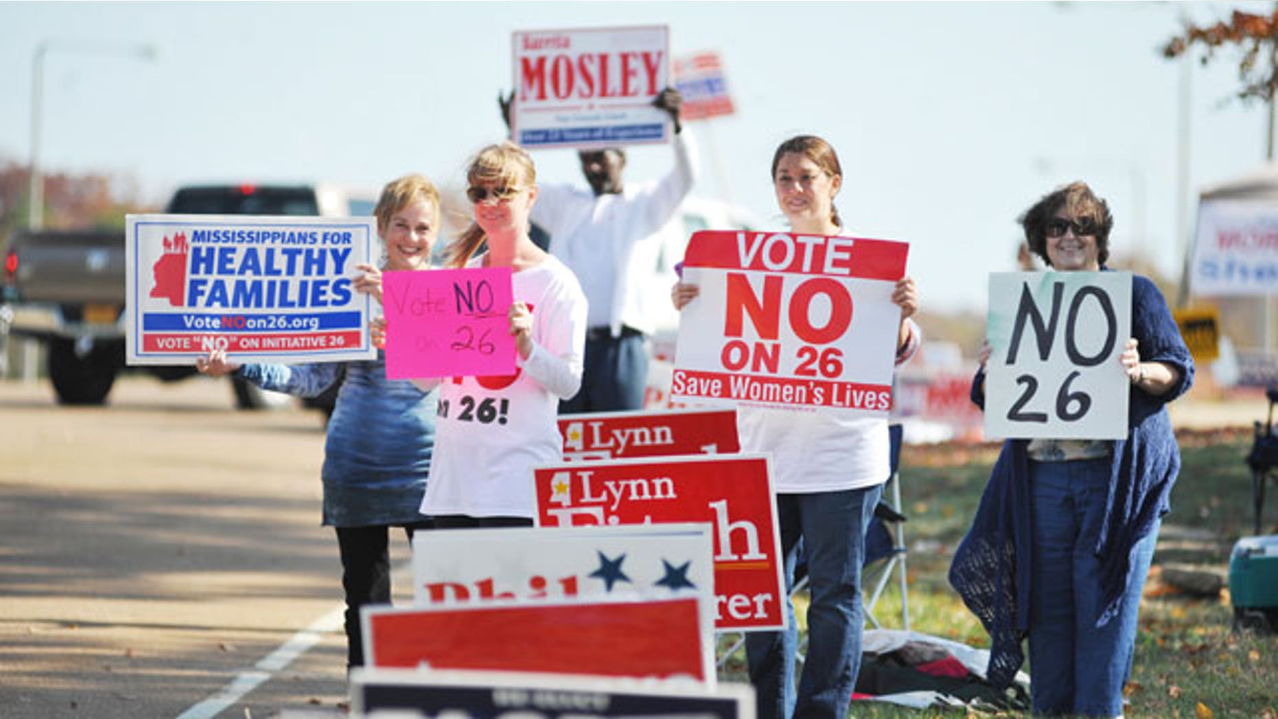 November 8, 2011: From the left, Ann Fisher-Wirth, Carley Dunavant, Jill Stevens, and Dicki King hold signs against Amendment 26 outside the polls at the Oxford Conference Center in Oxford, Miss.
