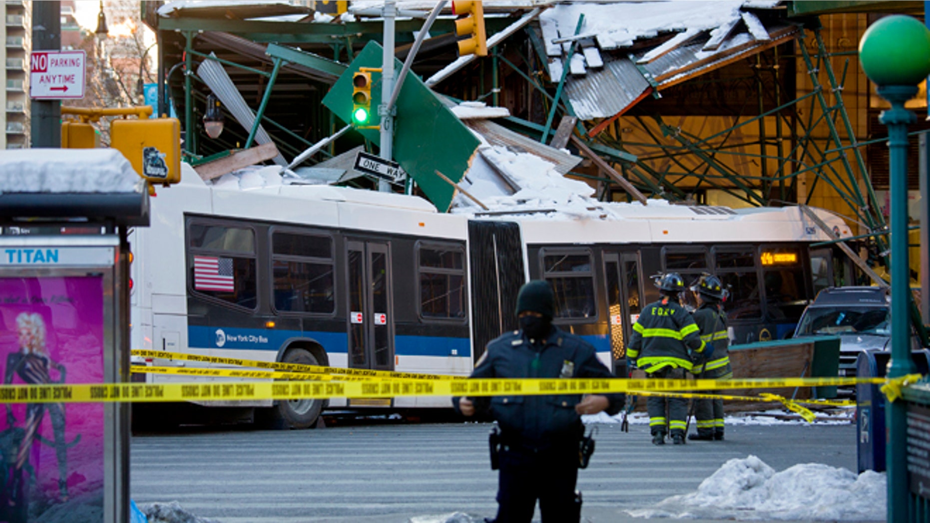 A Metropolitan Transportation Authority bus rests against scaffolding at 14th Street and 7th Avenue in New York, Wednesday, Feb. 12, 2014, after an early morning collision between the bus and a truck. One person was killed and at least four were injured in the crash, that also involved several parked vehicles. (AP Photo/Craig Ruttle)