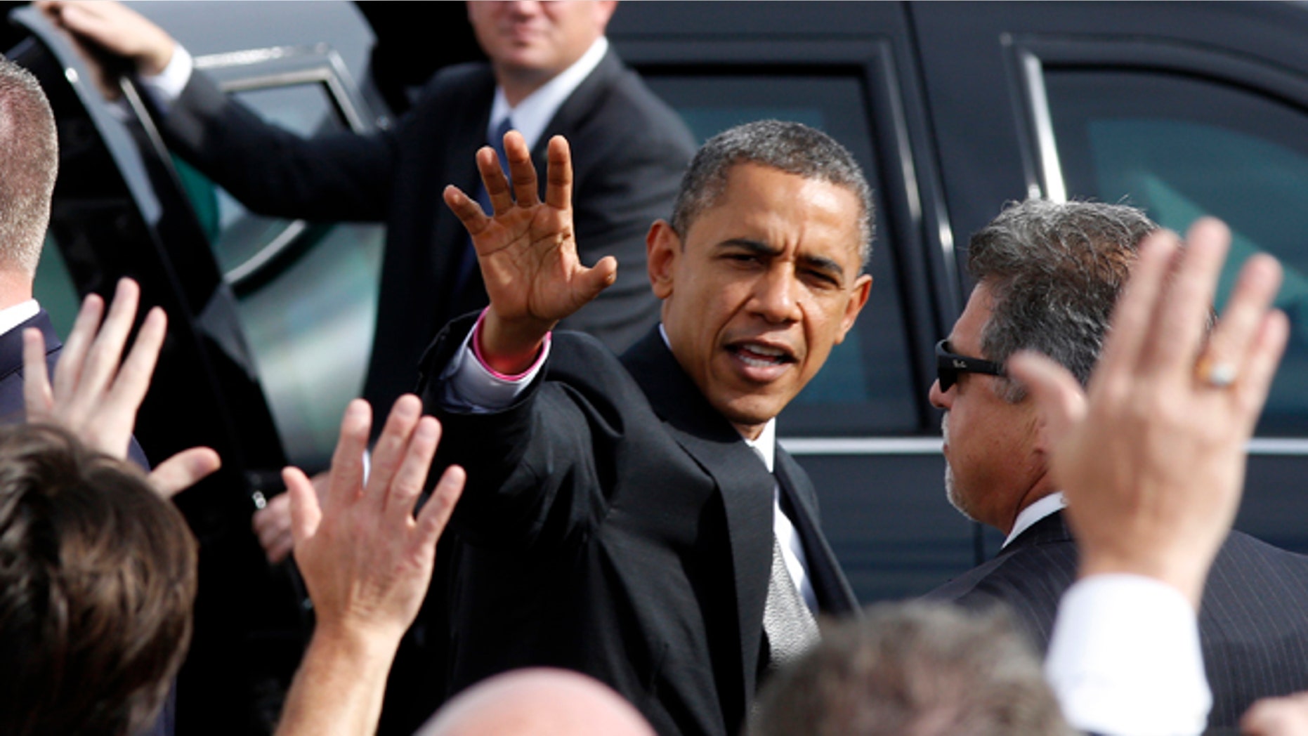 Oct. 23, 2012: President Barack Obama waves to a crowd on the tarmac as he leaves the Dayton International Airport for a campaign event in the Dayton, Ohio.