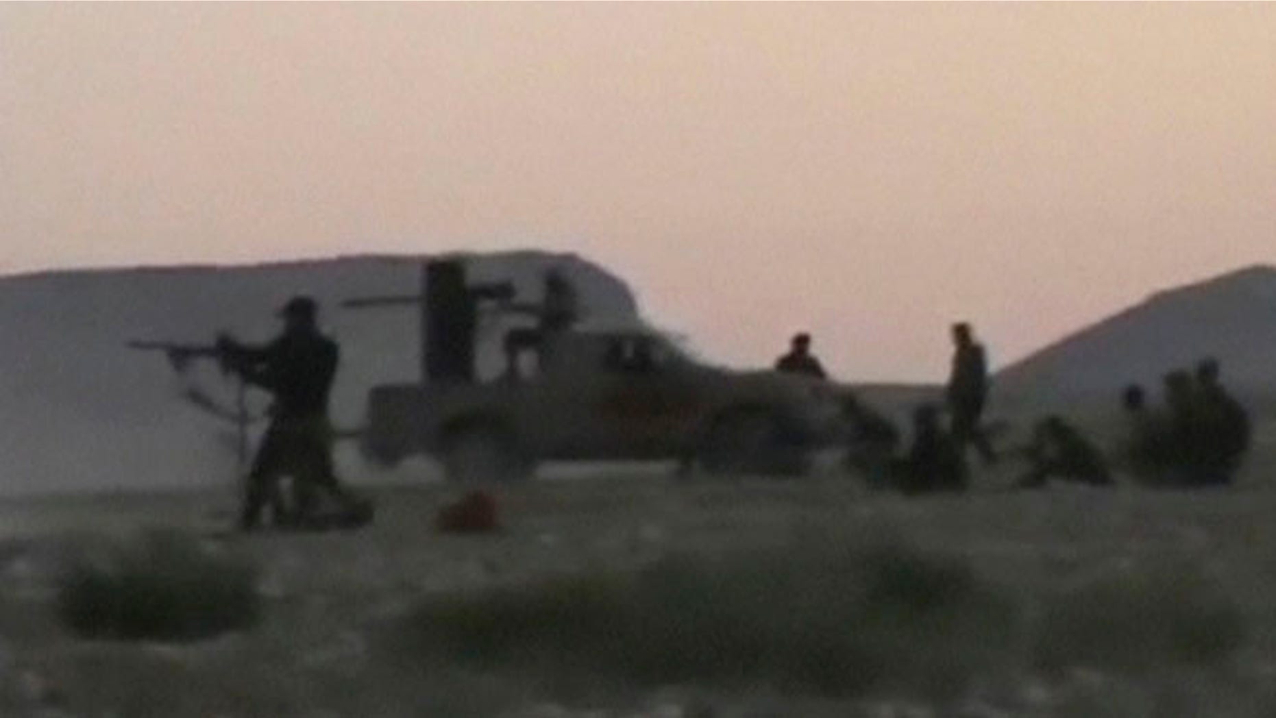 Sept. 4, 2013: Syrian rebels from the "Maghawir of Baba Amer" and "Baba Amer Revolutionaries" brigades exchange gunfire with Syrian government forces at a checkpoint in Maaloula, a suburb of Damascus, in this image taken from video footage obtained from a social media website. The unverified activist video said to be from Wednesday purportedly shows Syrian rebel forces storming the town of Maaloula and clashing with Syrian army troops at a checkpoint in the town that is home to a Christian majority.