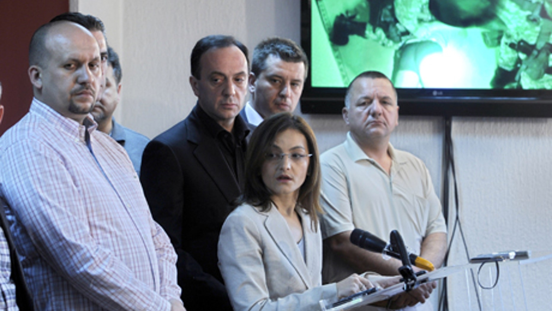 May 1, 2012: Macedonian Interior Minister Gordana Jankuloska, center front, talks to the media surrounded by her associates during a news conference in the capital Skopje. Macedonian authorities say they have arrested 20 people, all radical Islamists, in the murder of five Macedonian fishermen last month that fueled ethnic tensions in this tiny Balkan country. They have been charged with terrorism. (AP)