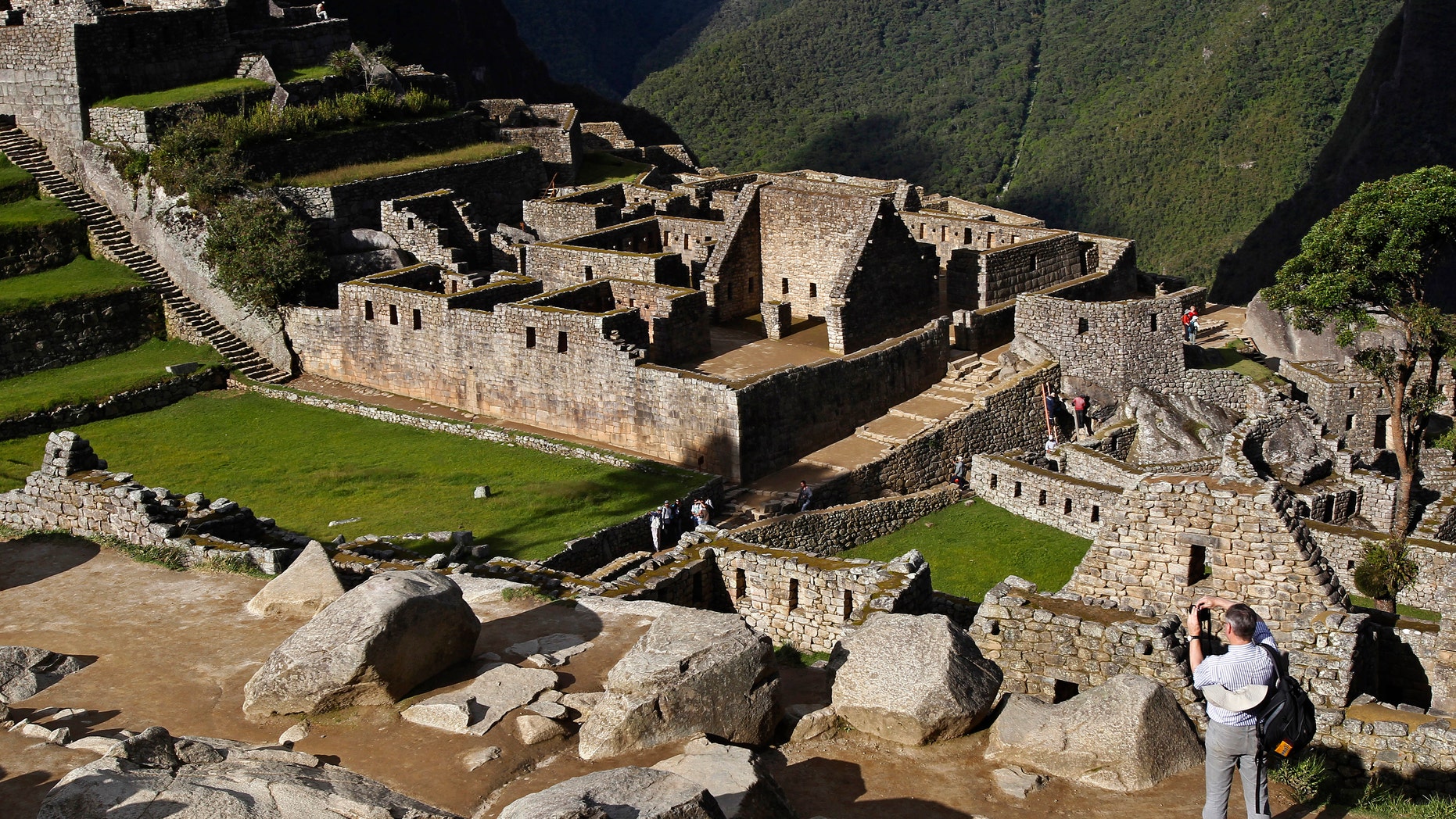 A visitor takes photos at the Inca citadel of Machu Picchu.