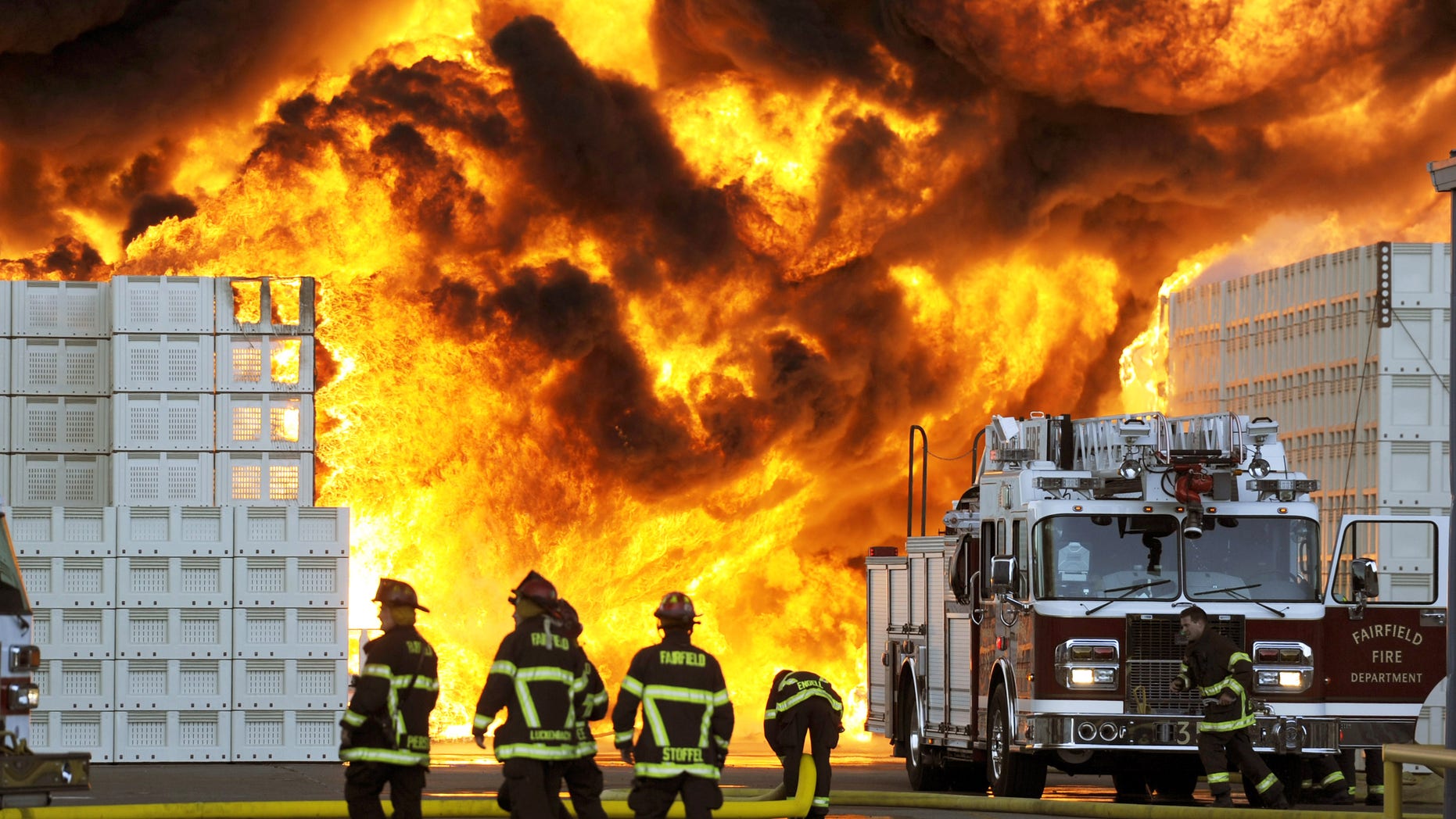 July 26: Firefighters prepare to reposition their ladder truck during their attack of a 6-alarm fire at the Macro Plastics manufacturing facility in Fairfield, California. According to fire officials, the 1:15 p.m. blaze started in the storage yard housing hundreds of plastic containers used for shipping agricultural products.