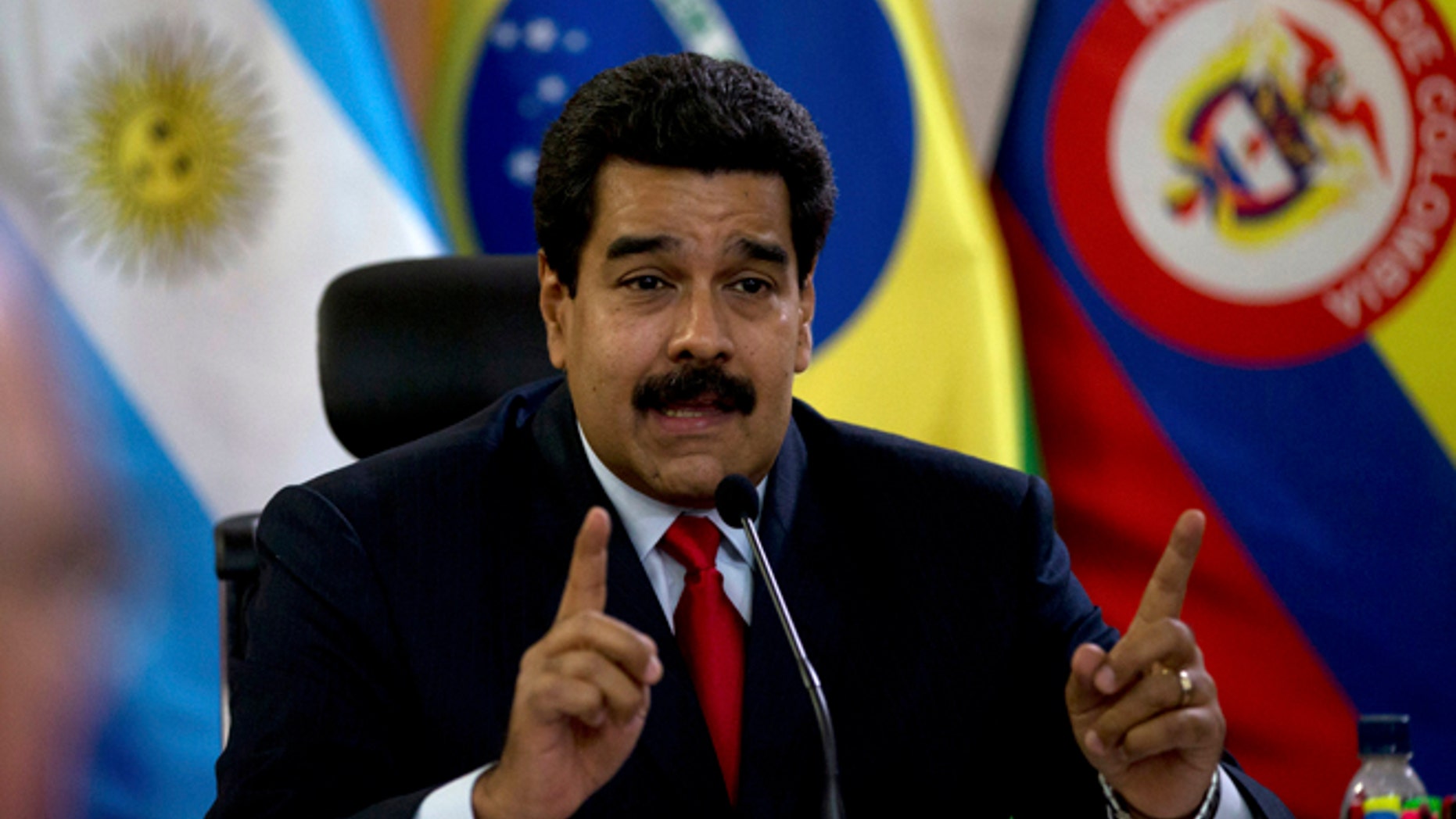 Venezuela's President Nicolas Maduro speaks at a meeting with a South American delegation of foreign ministers at the Miraflores Presidential Palace in Caracas, Venezuela, Tuesday, March 25, 2014. The foreign ministers representing the Union of South American Nations or UNASUR arrived Tuesday aimimg to ease political tensions and facilitate dialogue between Venezuela's government and opponents that are urging Maduro's resignation. (AP Photo/Fernando Llano)