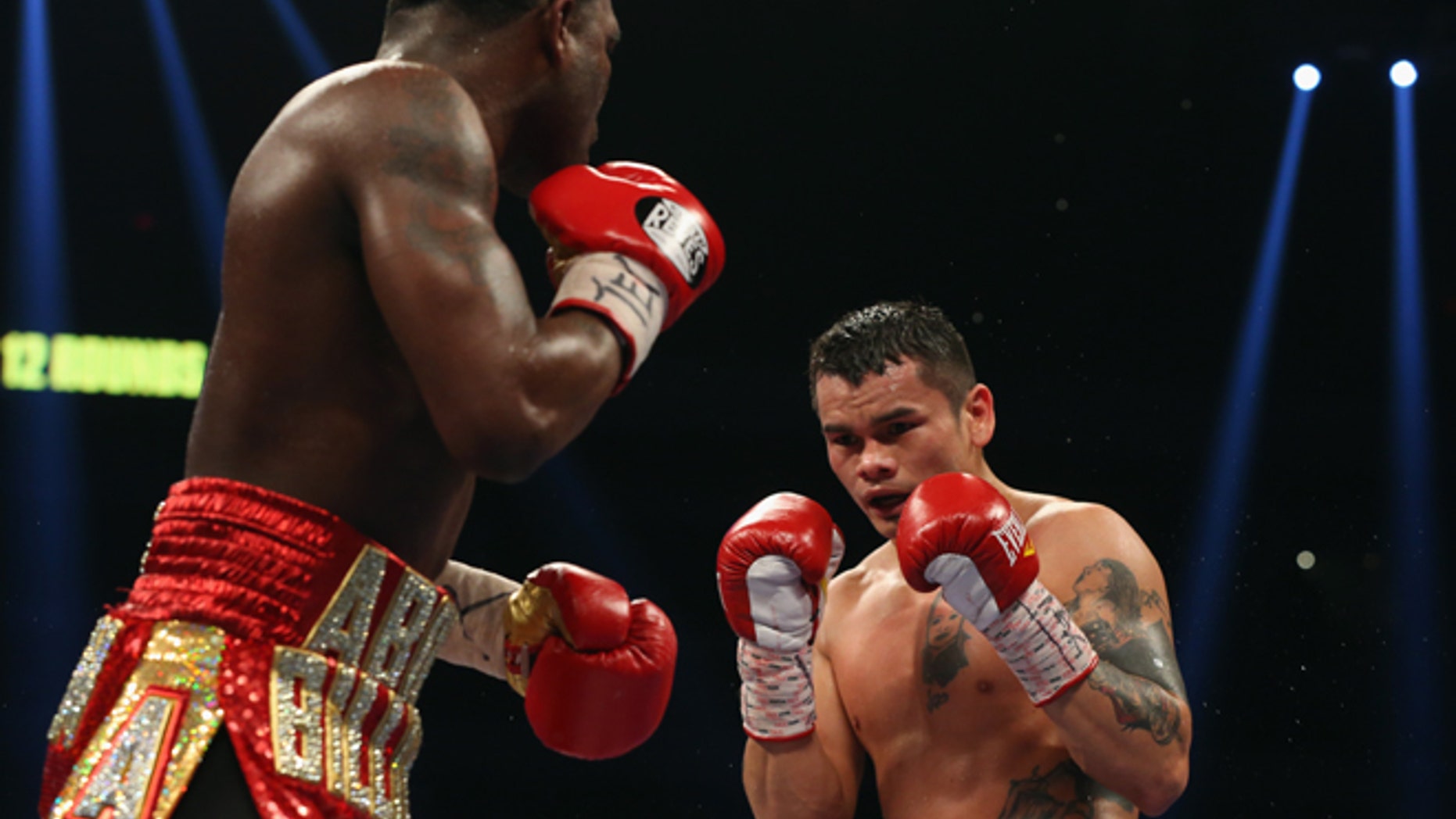 SAN ANTONIO, TX - DECEMBER 14: (L-R) Adrien Broner and Marcos Maidana during their WBA Welterweight Title bout at Alamodome on December14, 2013 in San Antonio, Texas.. (Photo by Ronald Martinez/Getty Images)