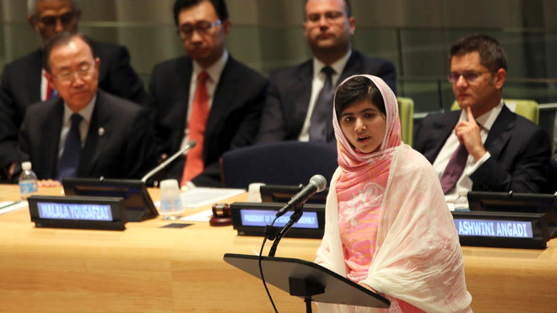 July 12, 2013: United Nations Secretary-General Ban Ki-moon, left, listens as Malala Yousafzai, right, addresses the Malala Day Youth Assembly at United Nations headquarters.
