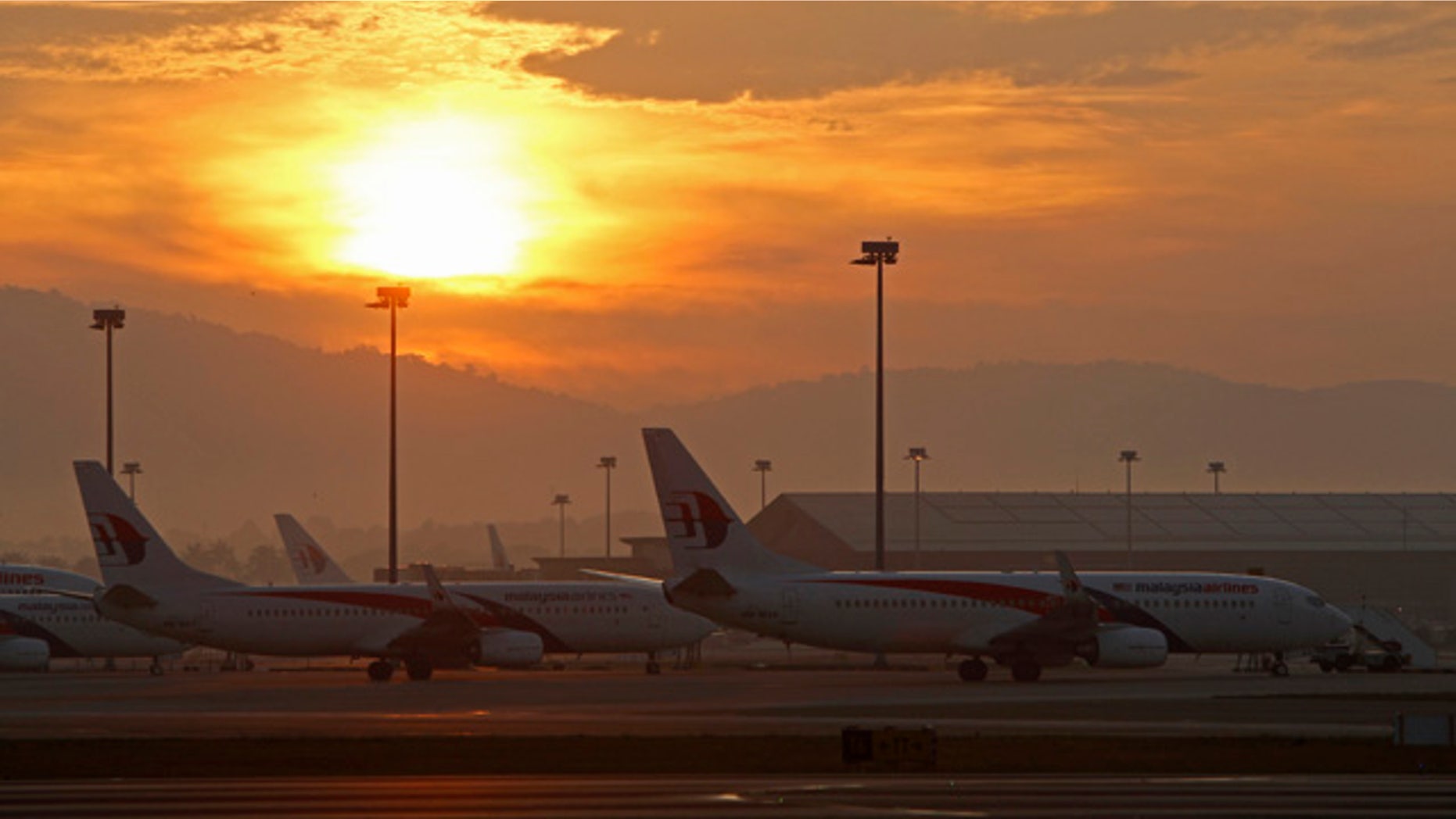 FILE - in this Sunday, Aug. 24, 2014 file photo, Malaysia Airlines planes taxi on the tarmac at Kuala Lumpur International Airport in Sepang, Malaysia. Malaysia Airlines has renamed a promotional competition asking people what activities and destinations are on their 'bucket list' after acknowledging it was inappropriate given the two deadly disasters it has suffered this year. (AP Photo/Lai Seng Sin, File)