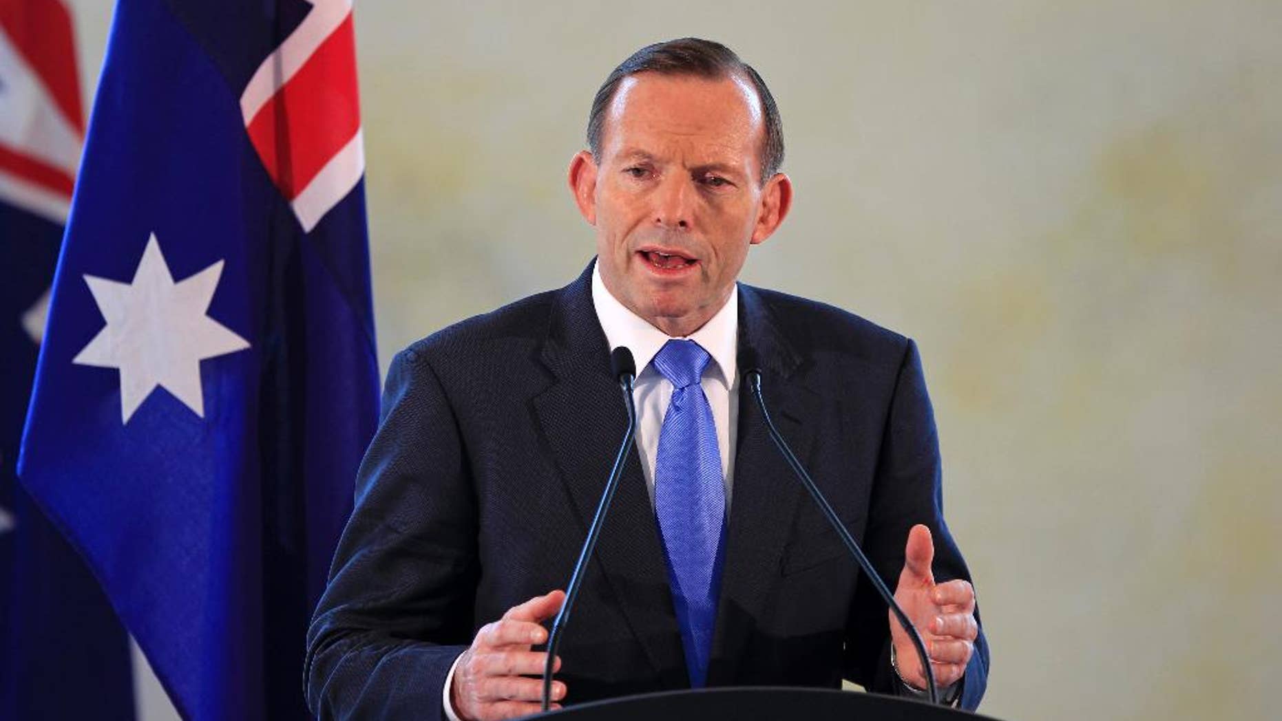 FILE - Australian Prime Minister Tony Abbott speaks during a joint press conference with his Malaysian counterpart Najib Razak after a meeting in Putrajaya, Malaysia, in this Saturday, Sept. 6, 2014 file photo. Australia is preparing to contribute up to 10 military aircraft to the increasingly aggressive campaign against the Islamic State extremists in Syria and Iraq. Abbott said Sunday Sept. 14, 2014 in a statement that Australia was responding to a formal request from the United States for specific contributions to the international coalition. (AP Photo/Lai Seng Sin, File)