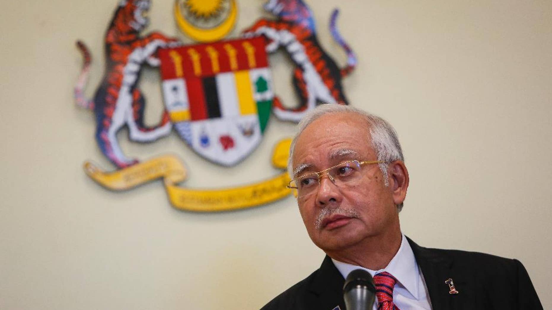 FILE - In this Aug. 14, 2015, file photo, Malaysian Prime Minister Najib Razak pauses while speaking at a press conference in Putrajaya, Malaysia. Malaysia's attorney general on Thursday, Oct. 8, 2015, defended the government over a debt scandal as the country's state rulers pushed for the investigation to be resolved quickly. The Conference of Rulers, which comprised nine state rulers and governors of four other states, issued a rare statement Tuesday saying that failure to give convincing answers and clarifications on state investment fund 1MDB have led to a "crisis of confidence" in the country. They called for a quick and transparent investigation into the fund. The fund, set up by Najib in 2009 to develop new industries, has been accused by critics of graft and mismanagement after it accumulated at least 42 billion ringgit ($10 billion) in debt. (AP Photo/Joshua Paul, File)
