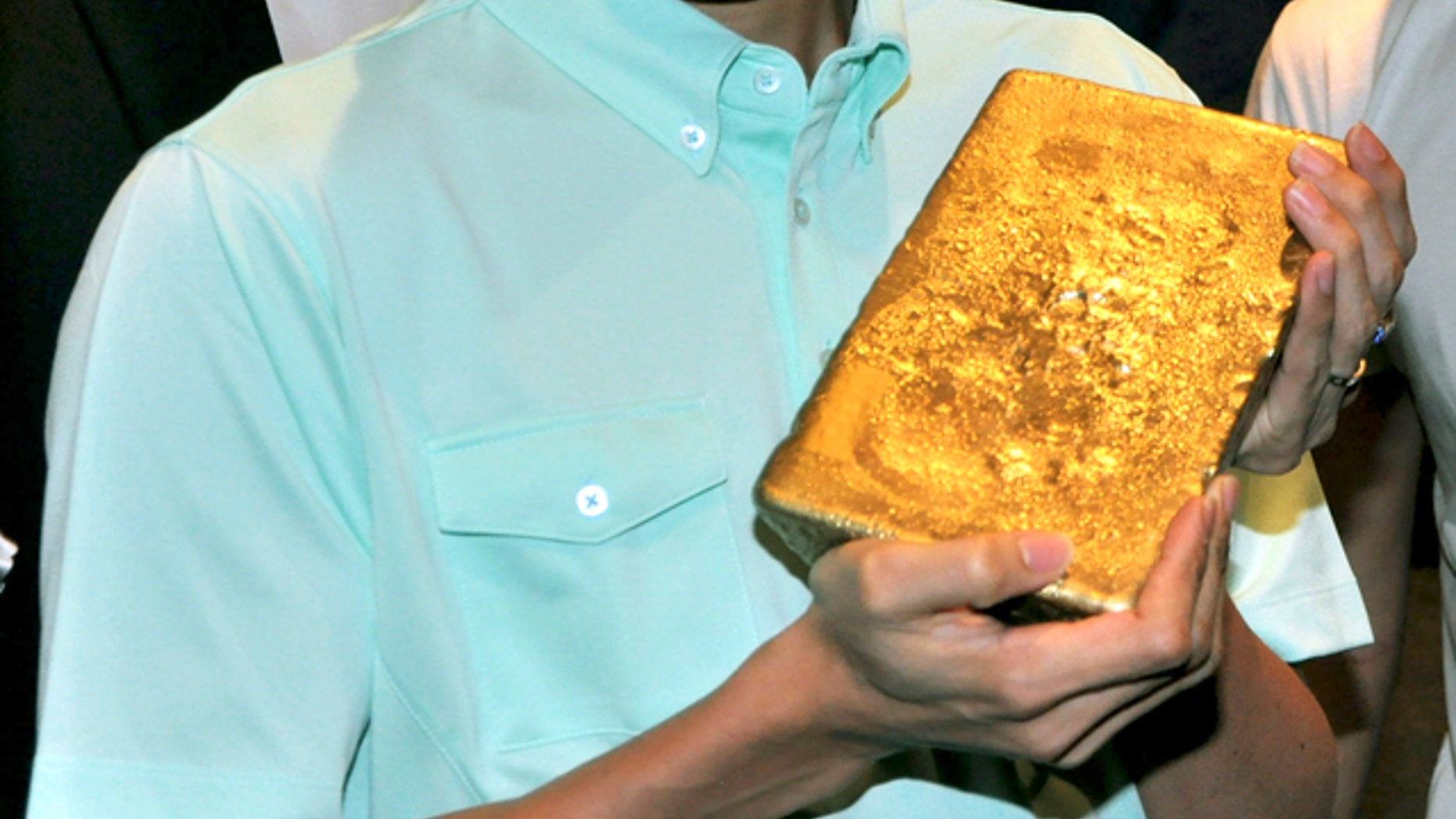 July 10, 2012: In this photo, Malaysian Olympic badminton player Lee Chong Wei holds a gold bar worth $627,795 during an incentive announcement for Olympic bound badminton players in Kuala Lumpur, Malaysia.