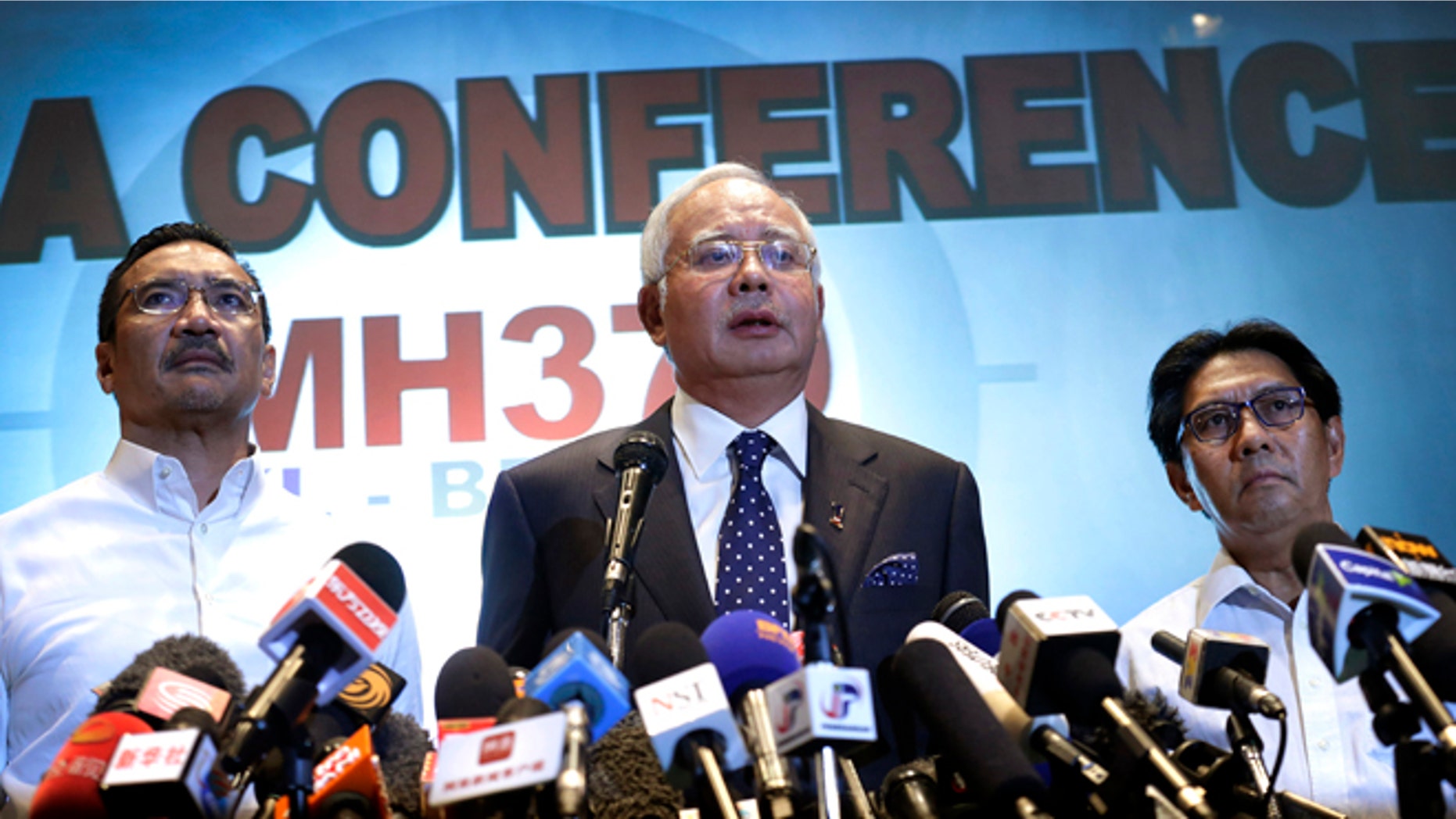 Malaysian Prime Minister Najib Razak, center, Malaysia's Minister for Transport Hishamuddin Hussein, left, and director general of the Malaysian Department of Civil Aviation, Azharuddin Abdul Rahman, delivers a statement to the media regarding the missing Malaysia Airlines jetliner MH370, Saturday, March 15, 2014 in Sepang, Malaysia. Najib said Saturday that investigators believe the missing Malaysian airliner's communications were deliberately disabled, that it turned back from its flight to Beijing and flew for more than seven hours. (AP Photo/Wong Maye-E)