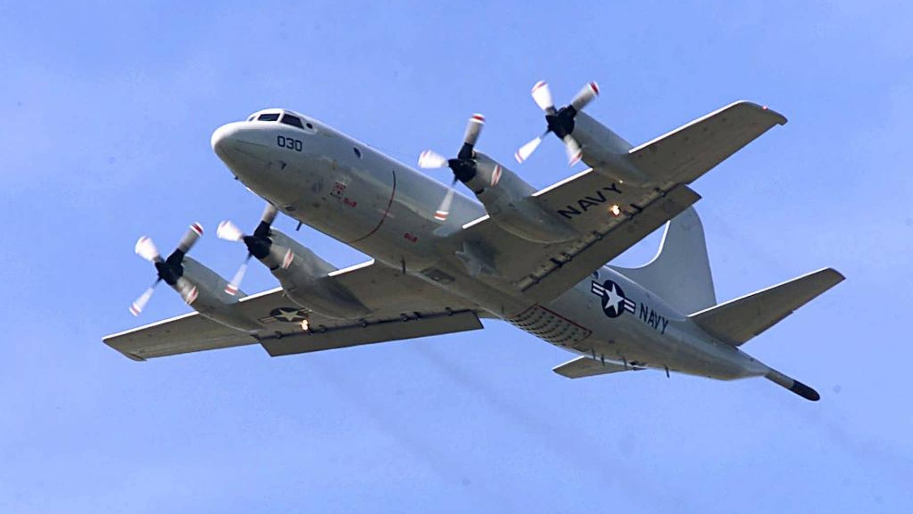 FILE - In this April 4, 2001 file photo, P-3C Orion practices touch-and-go landings at Whidbey Island Naval Air Station near Oak Harbor, Wash. The similar type of the P-3 Orion, favored by the Australian and New Zealand defense forces, is used in the search for the Malaysia Airlines Flight 370 which went missing on March 8, 2014, off the west coast of Australia. Because the search area is so remote, it’s an eight-hour round trip, leaving the planes just two or three hours to search. (AP Photo/Stevan Morgain, File)