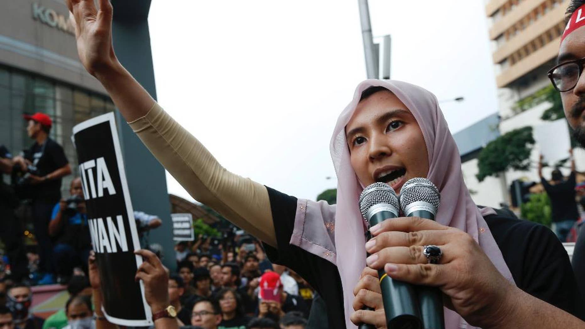 FILE - In this Saturday, March 7, 2015 file photo, lawmaker and a vice-president of the People's Justice Party Nurul Izzah Anwar, daughter of oppression leader Anwar Ibrahim, speaks to protesters as they gather to demand the freedom of Anwar, in downtown Kuala Lumpur. Malaysian police arrested Monday, March 16, the eldest daughter of jailed Anwar Ibrahim for alleged sedition, a move slammed by critics as a clampdown on dissent. He began a 5-year prison sentence on Feb. 10 after being found guilty of sodomizing a former male aide in 2008. Anwar has maintained his innocence and claims he is a victim of a political vendetta by the government. (AP Photo/Vincent Thian, File)