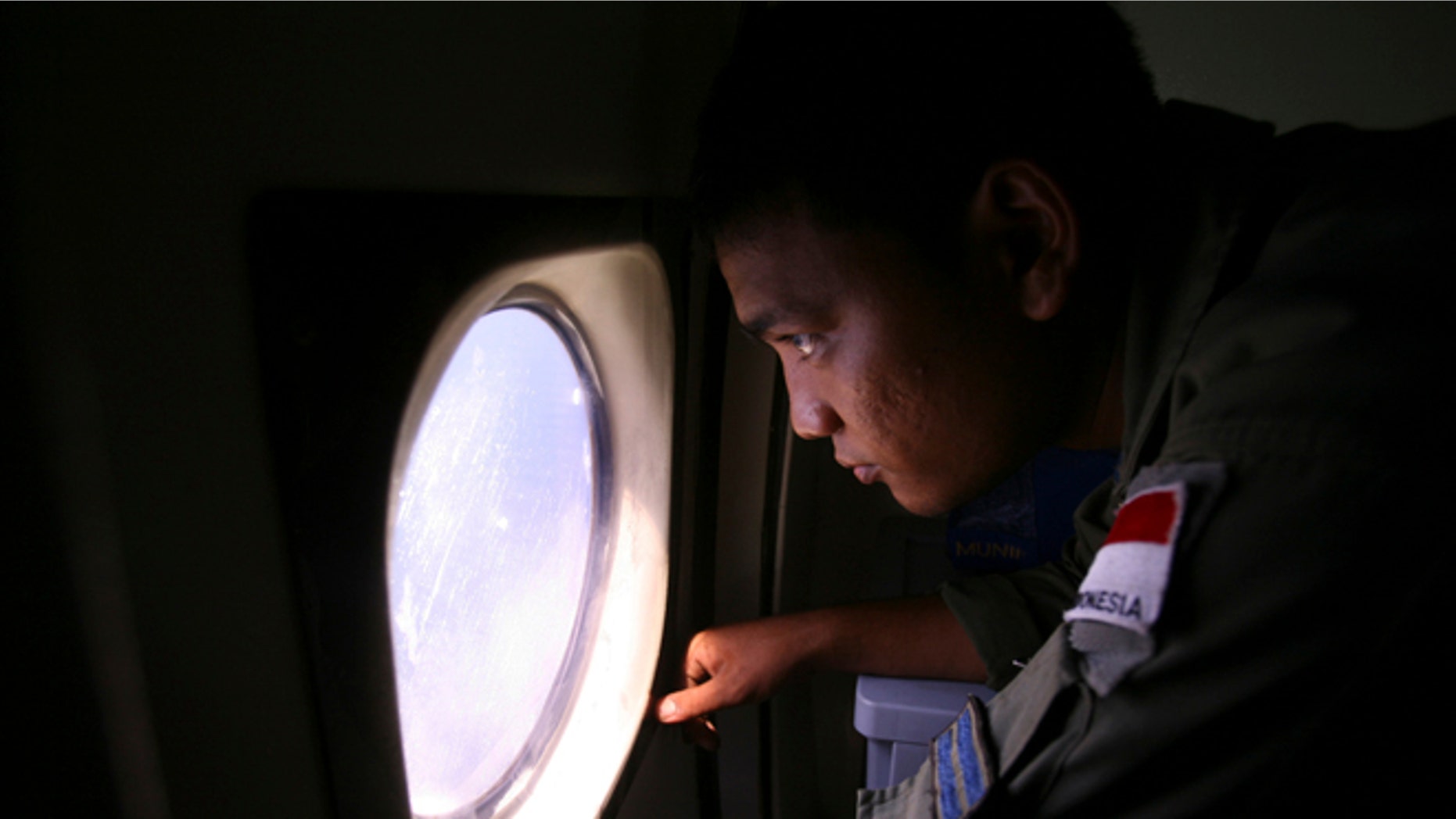 An Indonesian Navy crew member scans the water bordering Indonesia, Malaysia and Thailand during a search operation for the missing Malaysian Airlines Boeing 777 near the Malacca straits on Monday, March 10, 2014. Dozens of ships and aircraft have failed to find any piece of the missing Boeing 777 jet that vanished more than two days ago above waters south of Vietnam as investigators pursued "every angle" to explain its disappearance, including hijacking, Malaysia's civil aviation chief said Monday. (AP Photo/Binsar Bakkara)