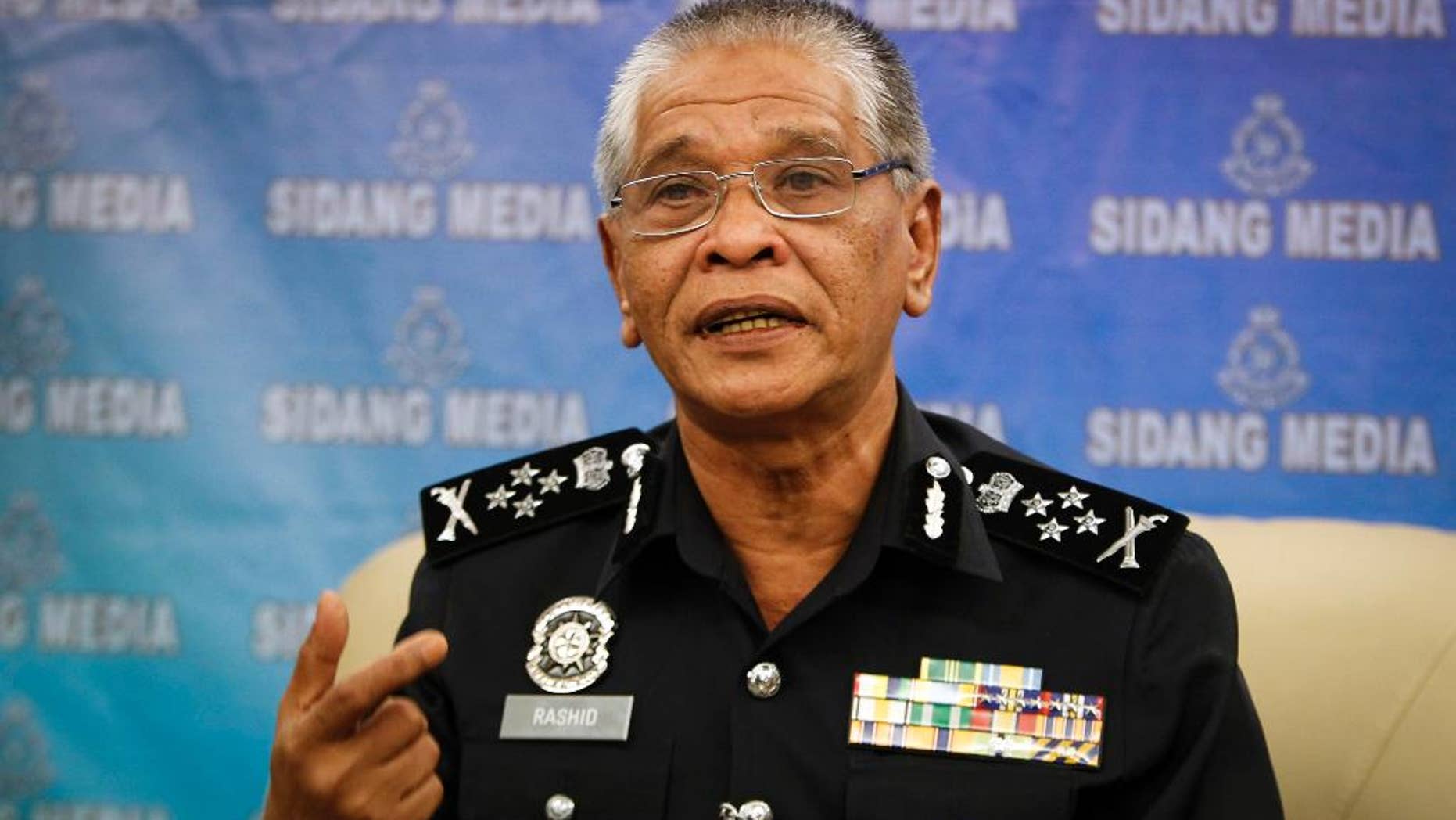 Malaysian police Deputy Inspector Gen. Noor Rashid Ibrahim gestures as he speaks during a press conference at the police headquarters in Kuala Lumpur, Malaysia Wednesday, Sept. 23, 2015. He says eight people, including four believed to be ethnic Uighurs, have been detained in connection with last month's bombing of a shrine in Bangkok that killed 20 people. (AP Photo/Joshua Paul)
