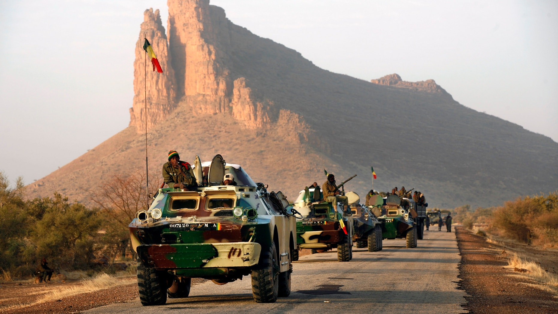 Feb. 4, 2013 - A convoy of Malian troops makes a stop to test some of their weapons near Hambori, northern Mali, on the road to Gao.