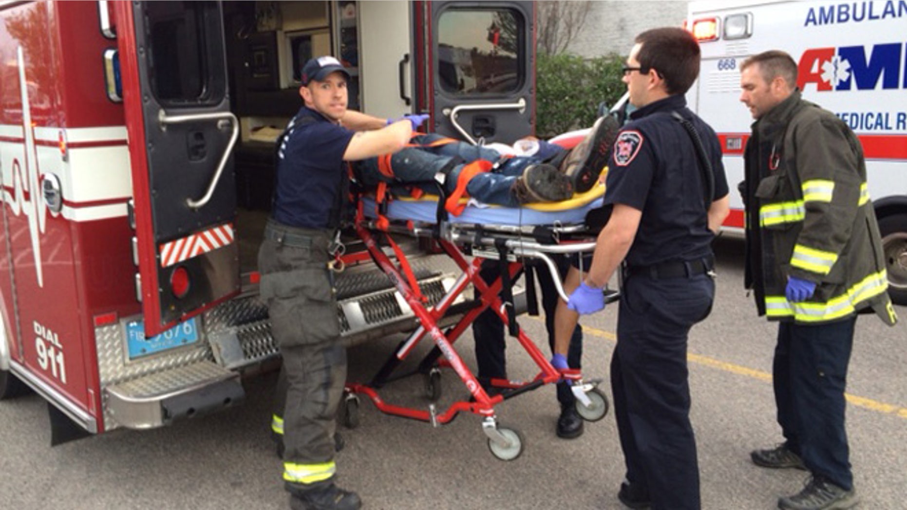 The suspect is transported on a gurney into an ambulance in Taunton, Mass., Tuesday, May 10, 2016.