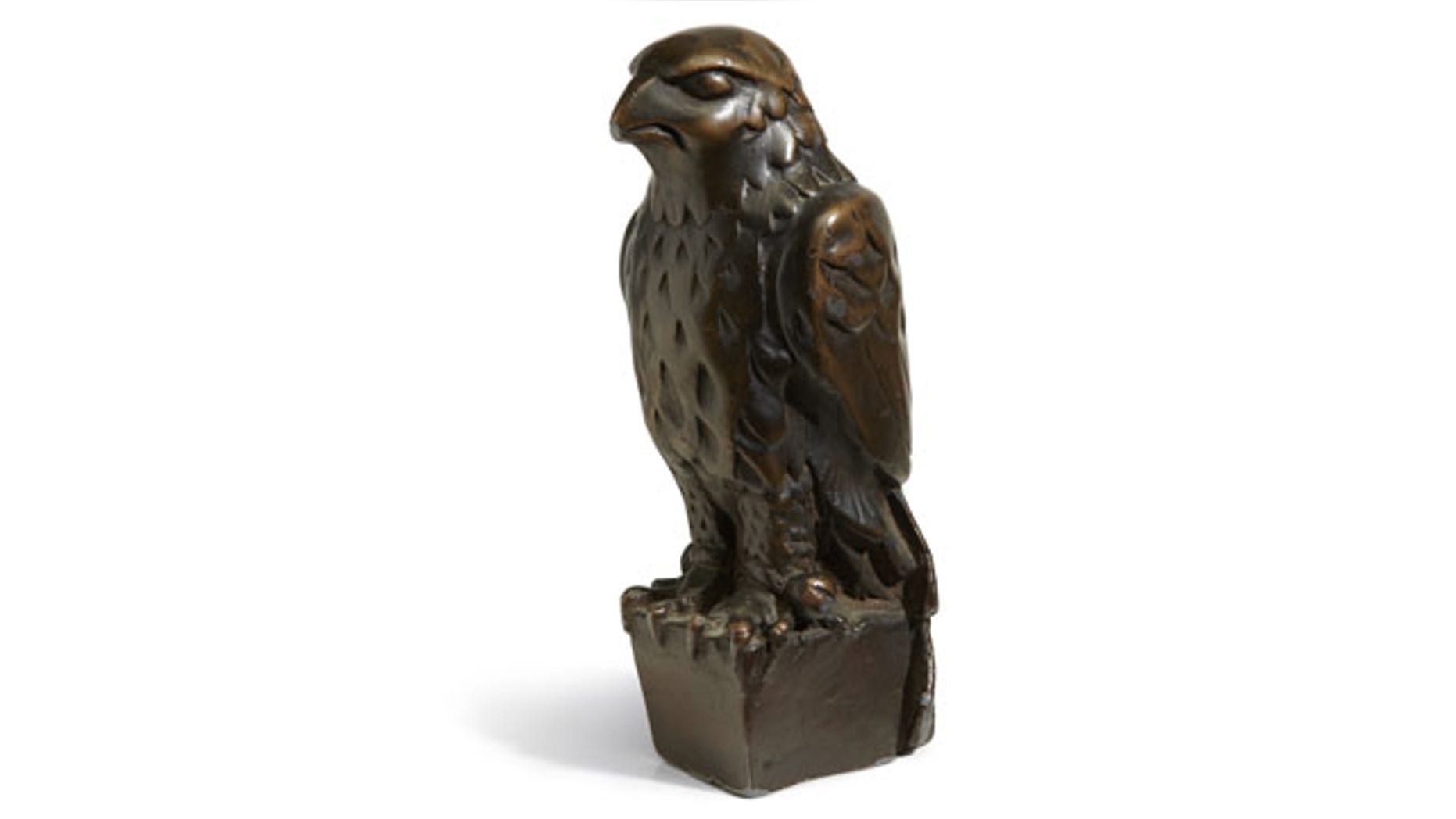 November 25, 2013: In this undated photo provided by Bonham’s Auction House, the “Maltese Falcon” is shown. The 45-pound, 12-inch-tall, black figurine cast in lead that was specifically made for John Huston's screen version of the film bears its name, sold for more than $4 million at auction by Bonham’s in New York. (AP Photo)