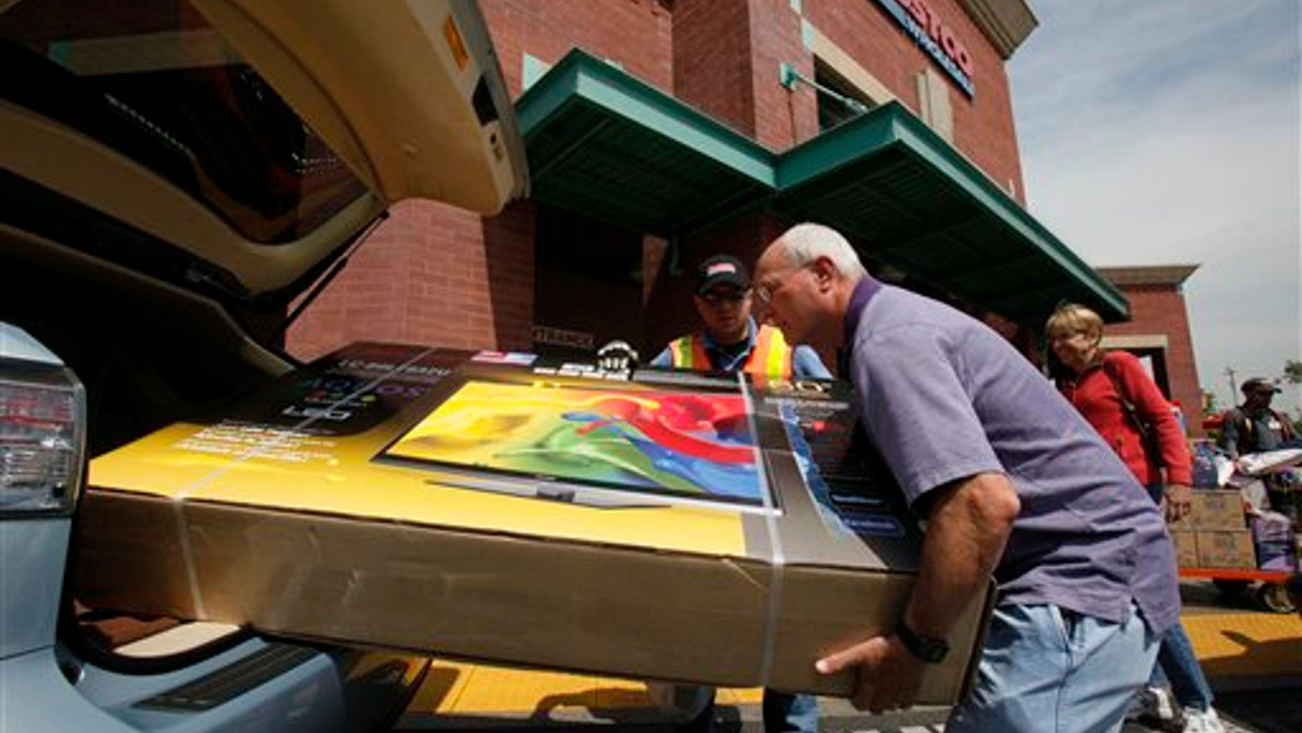 April 6: Shoppers load a newly purchased television in their car at the Los Feliz Costco Wholesale store Glendale, California.