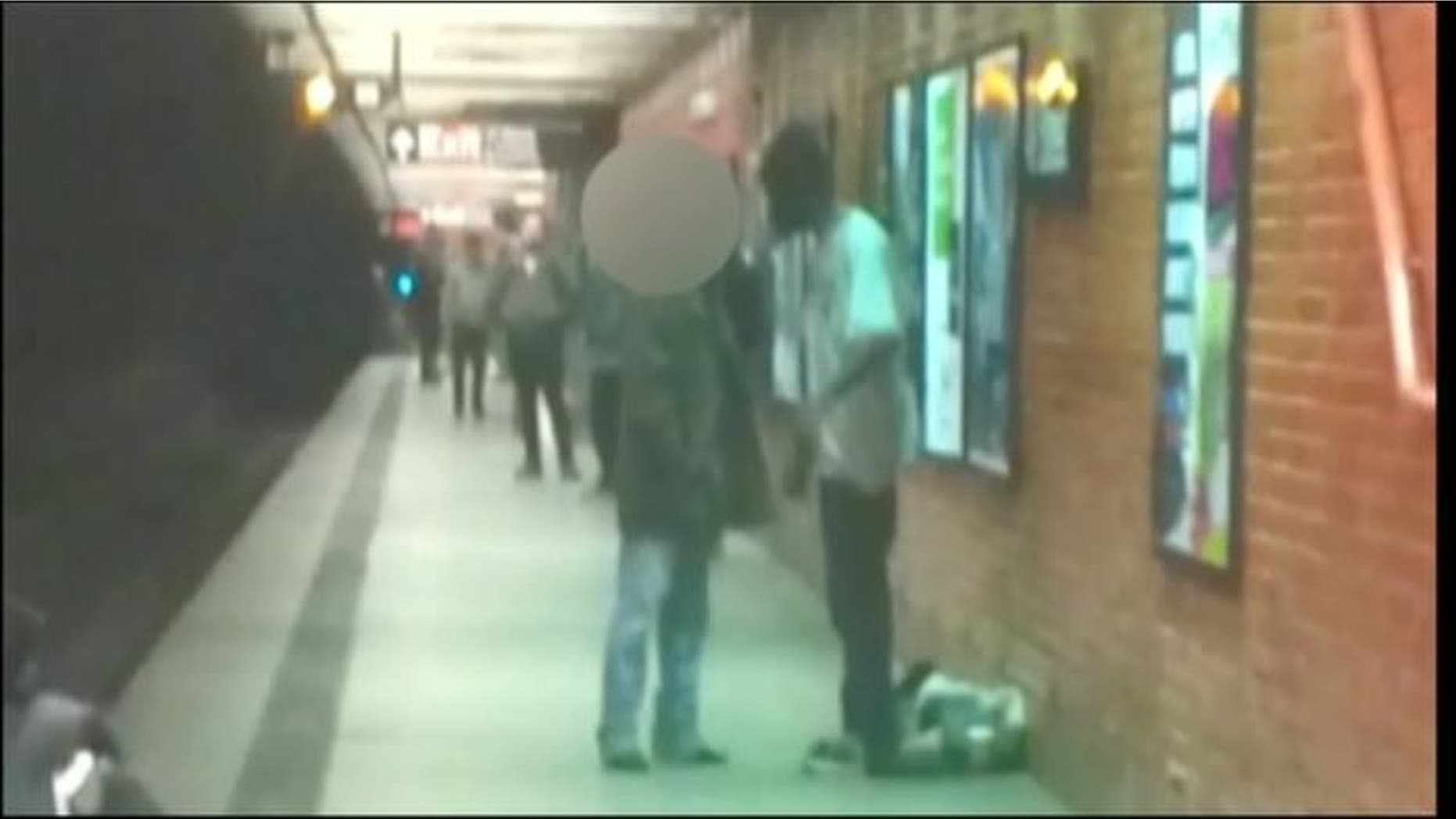 Dec. 3, 2012: An alleged suspect in subway train pushing and another man talk on platform.
