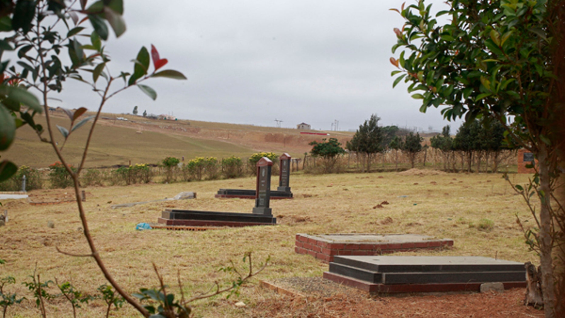 July 1, 2013: The Mandela family grave, right, where the remains of three family members of former South African president Nelson Mandela was previously were removed by his grandson in Qunu, South Africa.