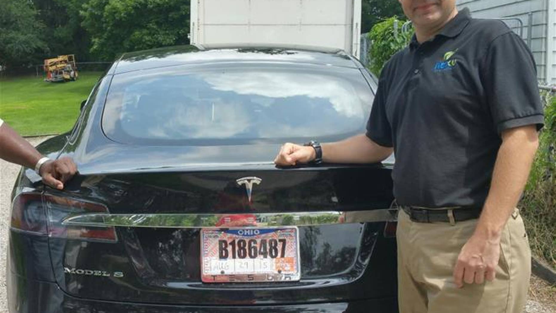 Joshua Brown stands by his new Tesla in 2015. Last month, he was killed while the car was in autopilot.
