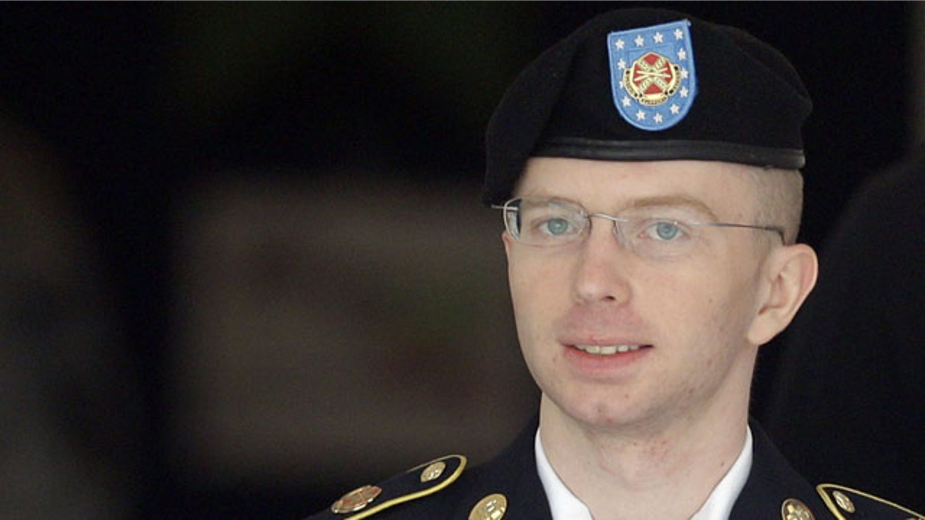 FILE - In this Aug. 16, 2013, file photo, Army Pfc. Bradley Manning is escorted to a security vehicle outside a courthouse in Fort Meade, Md., after a hearing in his court martial. (AP Photo)