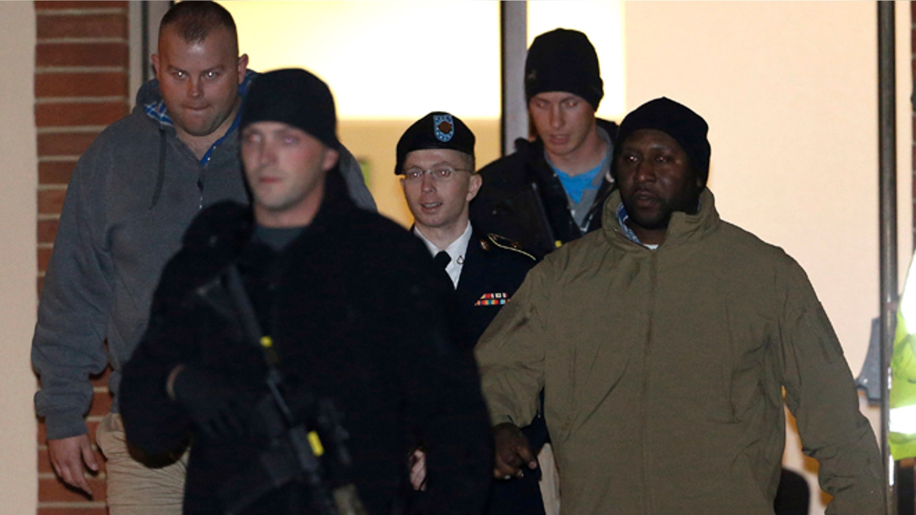 Nov. 27: Army Pfc. Bradley Manning, center, is heavily guarded as he is led out of a courthouse in Fort Meade, Md.