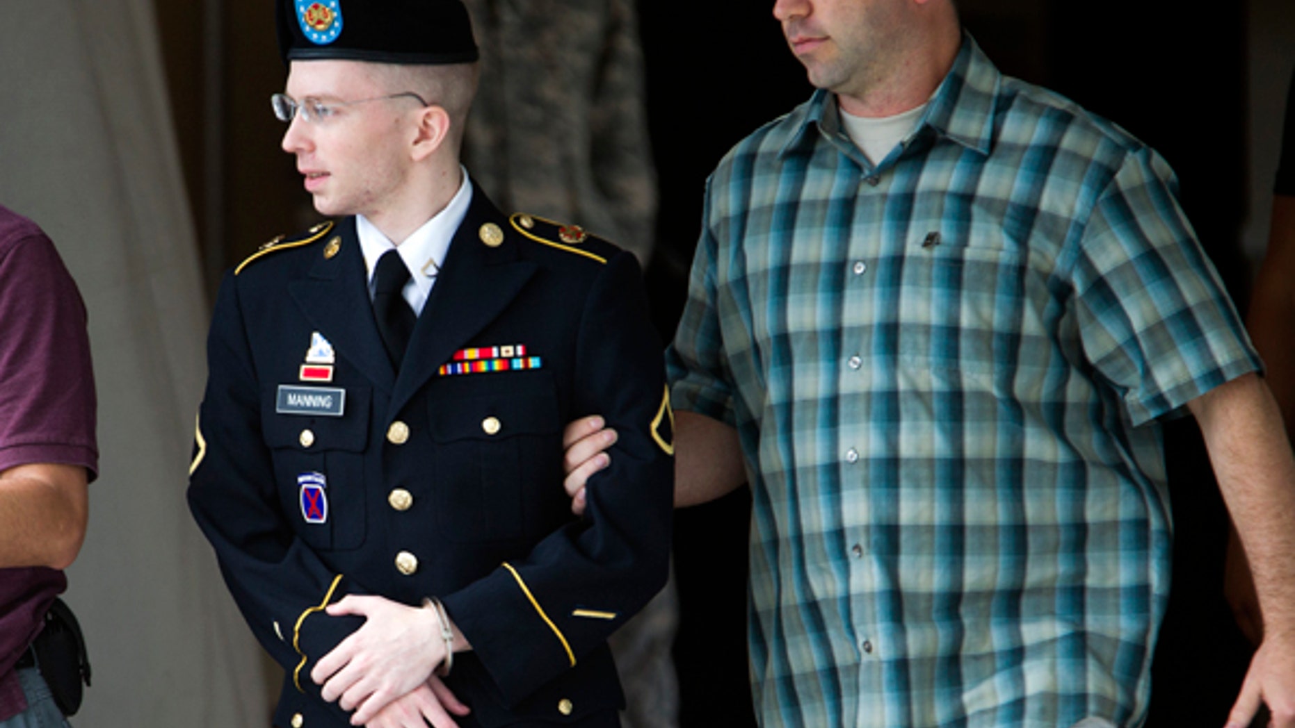 June 28, 2013: Army Pfc. Bradley Manning is escorted out of a courthouse in Fort Meade, Md., after another day of his court-martial, as he is charged with indirectly aiding the enemy by sending troves of classified material to WikiLeaks.