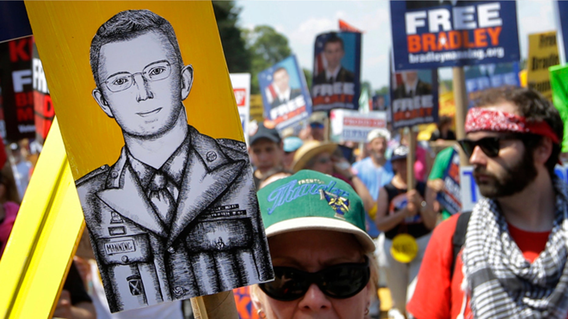 FILE: Saturday, June 1, 2013: Protesters march during a rally in support of Army Pfc. Bradley Manning outside of Fort Meade, Md.