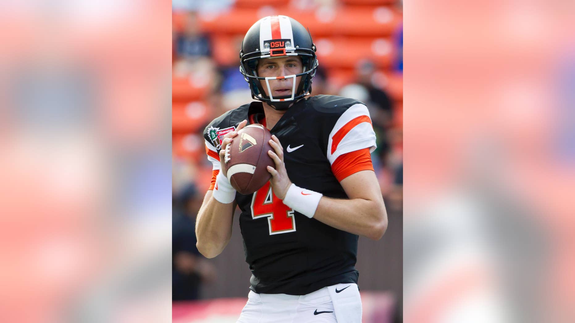FILE - In a Dec. 24, 2013, file photo Oregon State quarterback Sean Mannion looks for an open receiver in the second quarter of the Hawaii Bowl NCAA college football game against Boise State, in Honolulu. The once the soft-spoken and reserved quarterback for the Oregon State has blossomed into a confident full-fledged leader in his senior season for the Beavers. (AP Photo/Eugene Tanner, file)