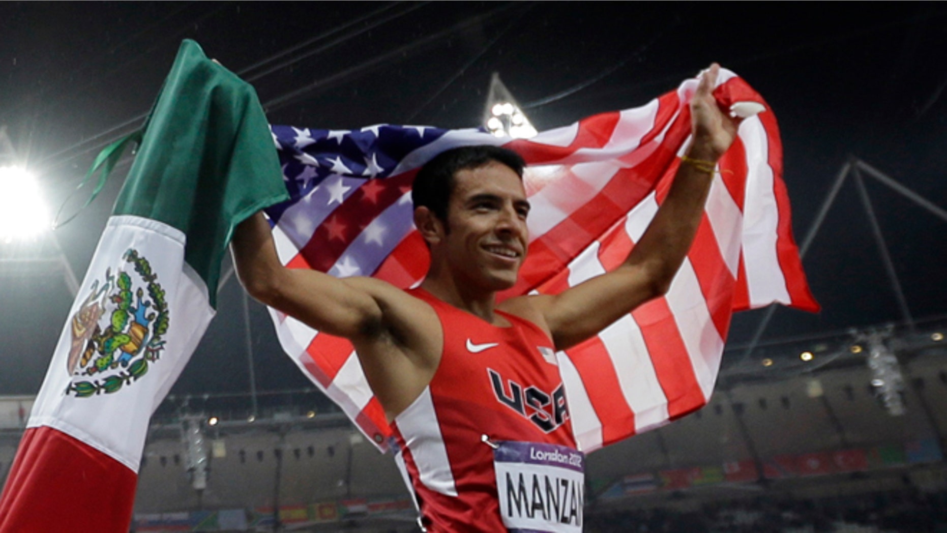 Gold medalist Taoufik Makhloufi of Algeria celebrates with silver medalist USA's Leonel Manzano after the men's 1500-meter during the athletics in the Olympic Stadium at the 2012 Summer Olympics, London, Tuesday, Aug. 7, 2012. (AP Photo/Matt Slocum)