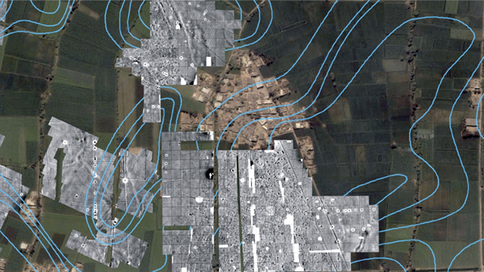 A color satellite image with radar imaging in monochrome showing the outlines of streets, houses and temples underneath the green farm fields and modern town of Tel al-Dabaa, in Egypt. An Austrian archaeological team has used radar imaging to determine the size of the 3,500-year-old capital of Egypt's foreign occupiers, the Hyksos warrior people from Asia, the antiquities department said Sunday.