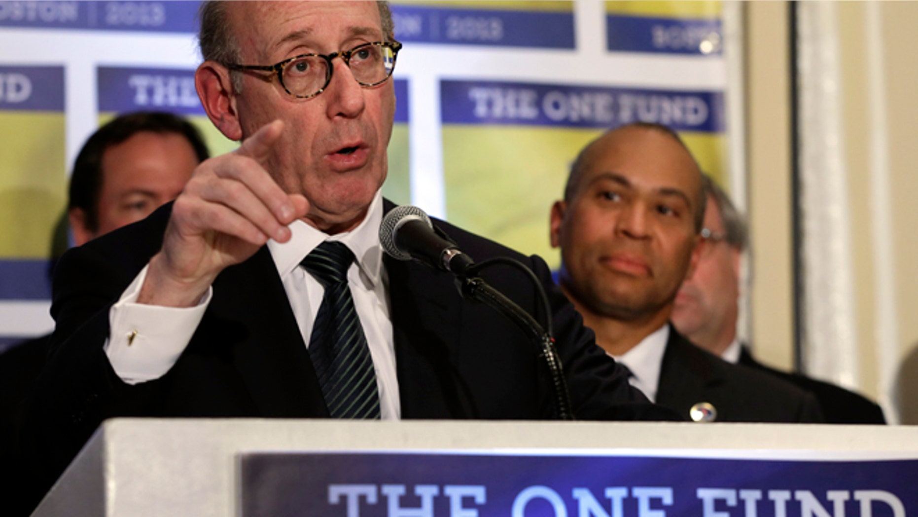 April 23, 2013: Kenneth Feinberg, an attorney who managed the 9/11 Victim Compensation Fund, speaks at a news conference in Boston, as Mass. Gov. Deval Patrick listens at right.