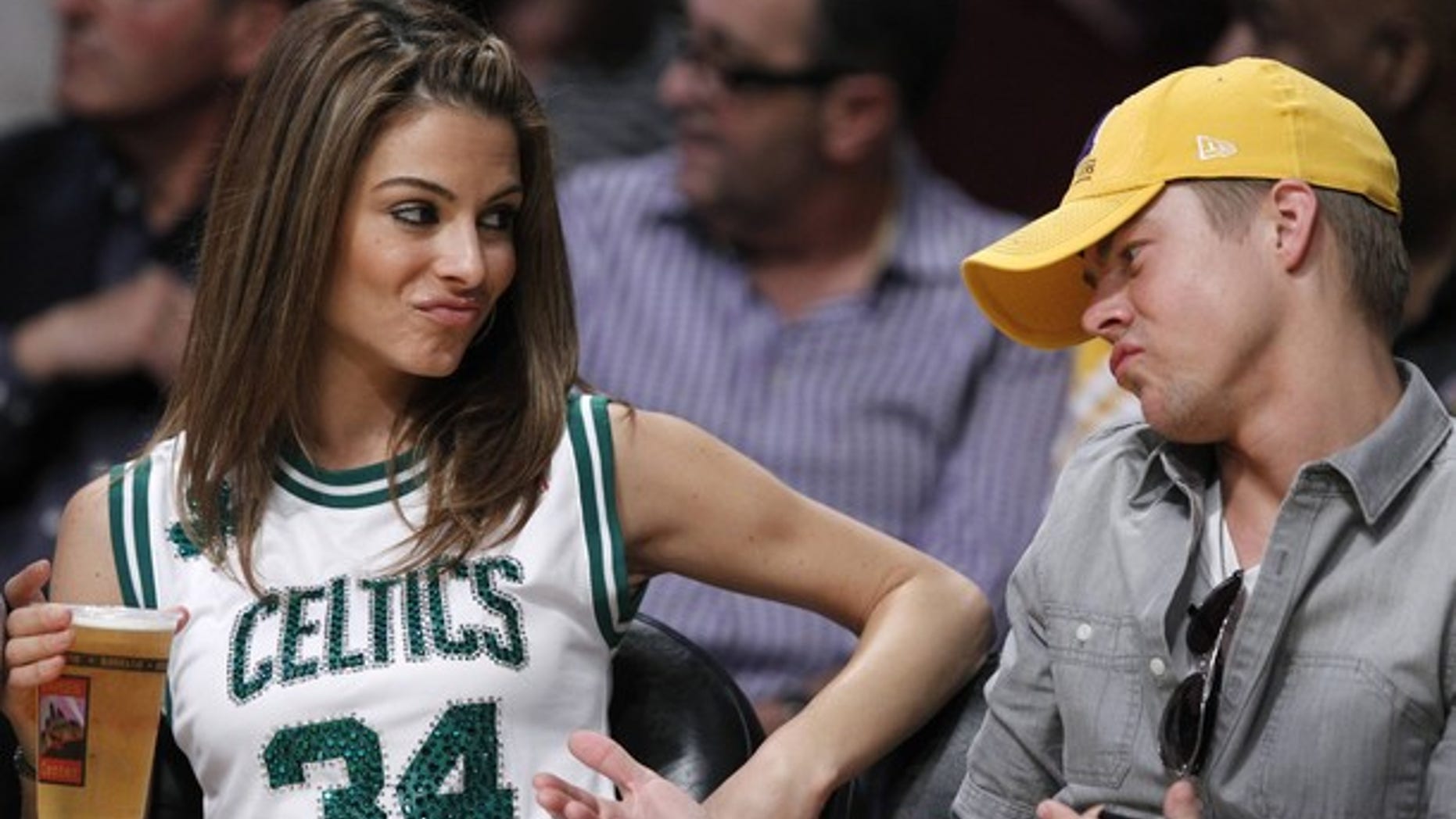 Actress Maria Menounos and "Dancing With the Stars" pro Derek Hough sit courtside as the Boston Celtics play the Los Angeles Lakers during their NBA basketball game in Los Angeles, California March 11, 2012. REUTERS/Lucy Nicholson (UNITED STATES - Tags: SPORT BASKETBALL ENTERTAINMENT)