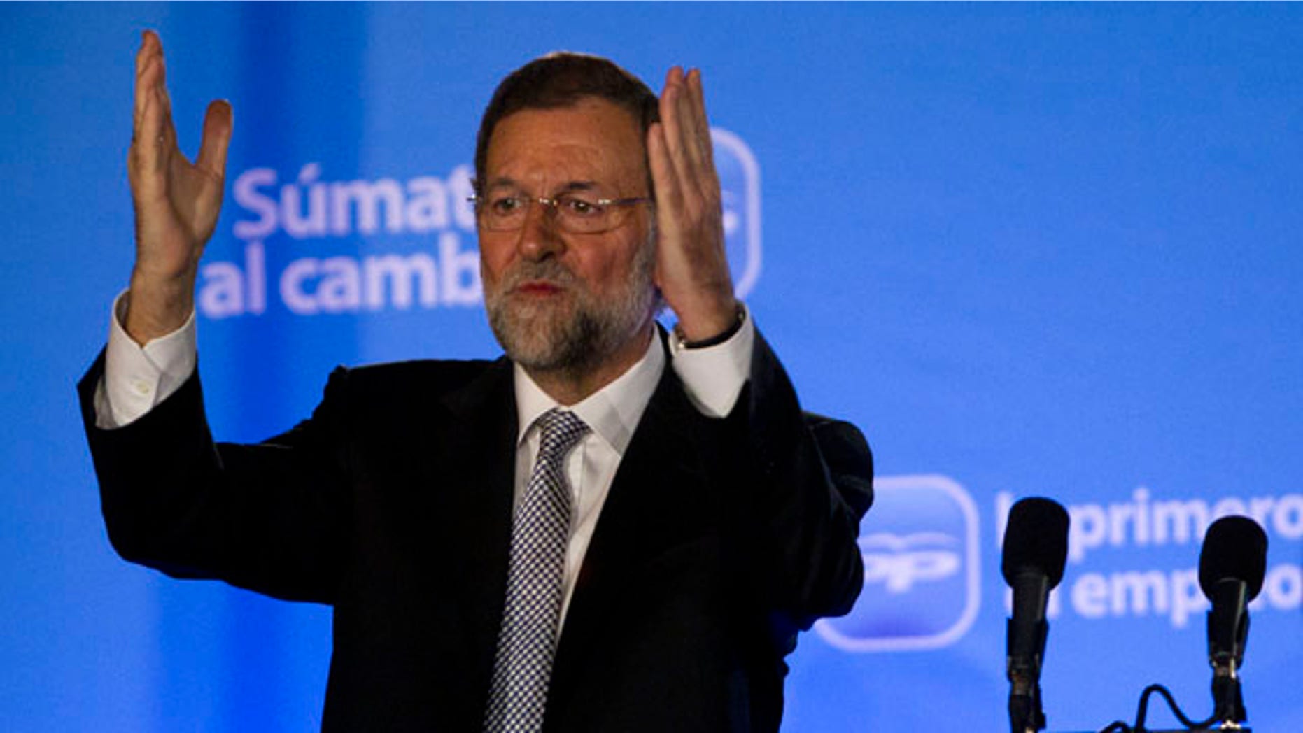 Conservative Popular Party candidate Mariano Rajoy waves next to his wife Elvira Fernandez Balboa after winning the general elections, in Madrid, Sunday Nov. 20, 2011. (AP Photo/Emilio Morenatti)