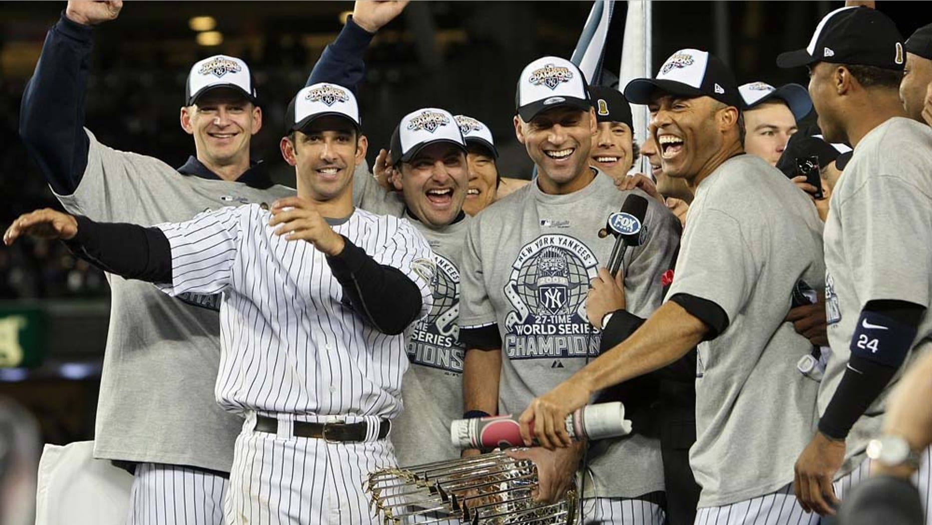 NEW YORK - NOVEMBER 04: A.J. Burnett (L), Jorge Posada (2nd L), Derek Jeter #2 (C) and Mariano Rivera #42 of the New York Yankees celebrate with their teammates after their 7-3 win against the Philadelphia Phillies in Game Six of the 2009 MLB World Series at Yankee Stadium on November 4, 2009 in the Bronx borough of New York City. (Photo by Nick Laham/Getty Images)