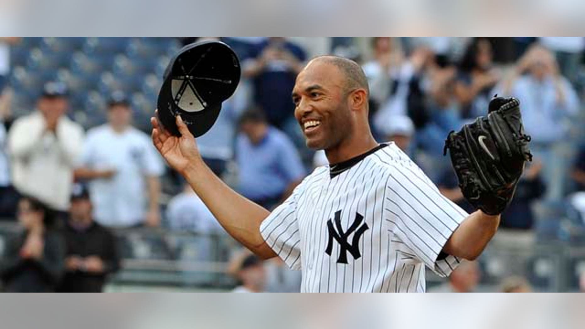 New York Yankees closer Mariano Rivera acknowledges the cheers of the crowd after recording his 602nd career save, after the Yankees beat the Minnesota Twins 6-4 in a baseball game, Monday, Sept. 19, 2011, at Yankee Stadium in New York. Rivera pitched a perfect ninth as he broke the record held by Trevor Hoffman. (AP Photo/Kathy Kmonicek)