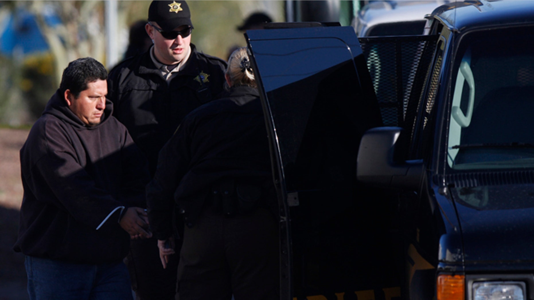 PHOENIX - FEBRUARY 11: A worker is arrested as Maricopa County Sheriffs conduct an immigration raid at HMI Contracting February 11, 2009 in Phoenix, Arizona. Several undocumented workers were arrested after County Sheriff Joe Arpaio ordered the raid on the company, which has a contract with the County Board of Supervisors to do landscaping at county buildings. (Photo by Joshua Lott/Getty Images)