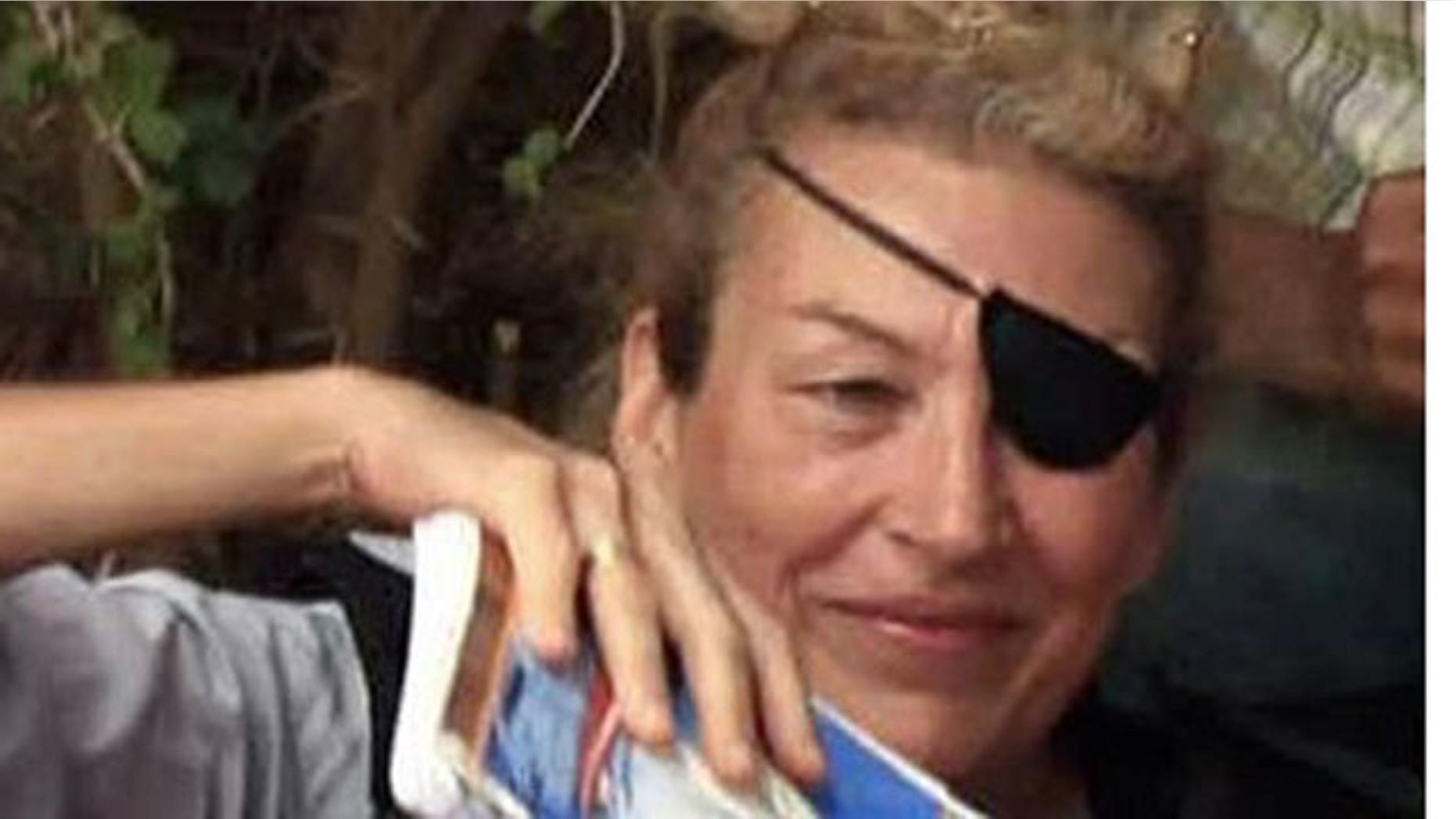 In this June 4, 2011 file photo, journalist Marie Colvin poses for a photograph with Libyan rebels (unseen) in Misrata.