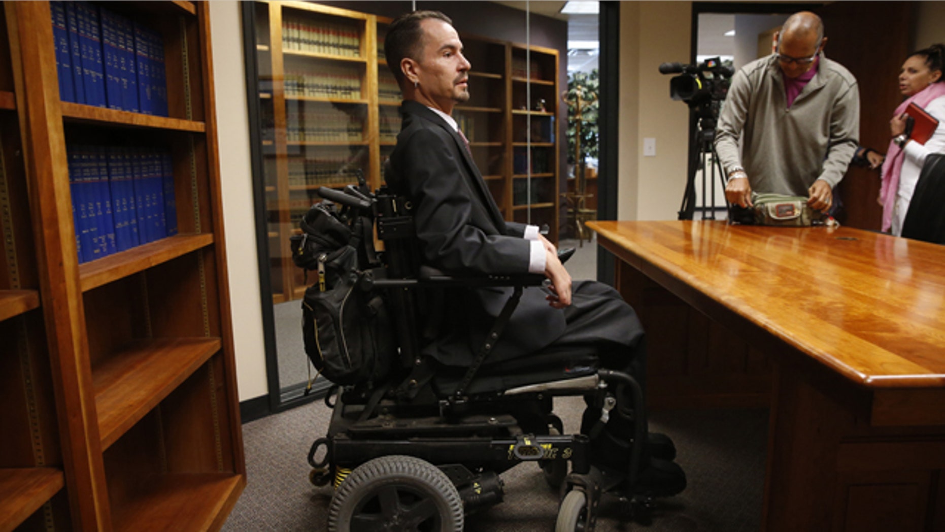 June 15, 2015: Brandon Coats prepares to take questions from members of the media after the Colorado Supreme Court ruled against him, at his attorney's offices in Centennial, Colo. (AP Photo/Brennan Linsley)