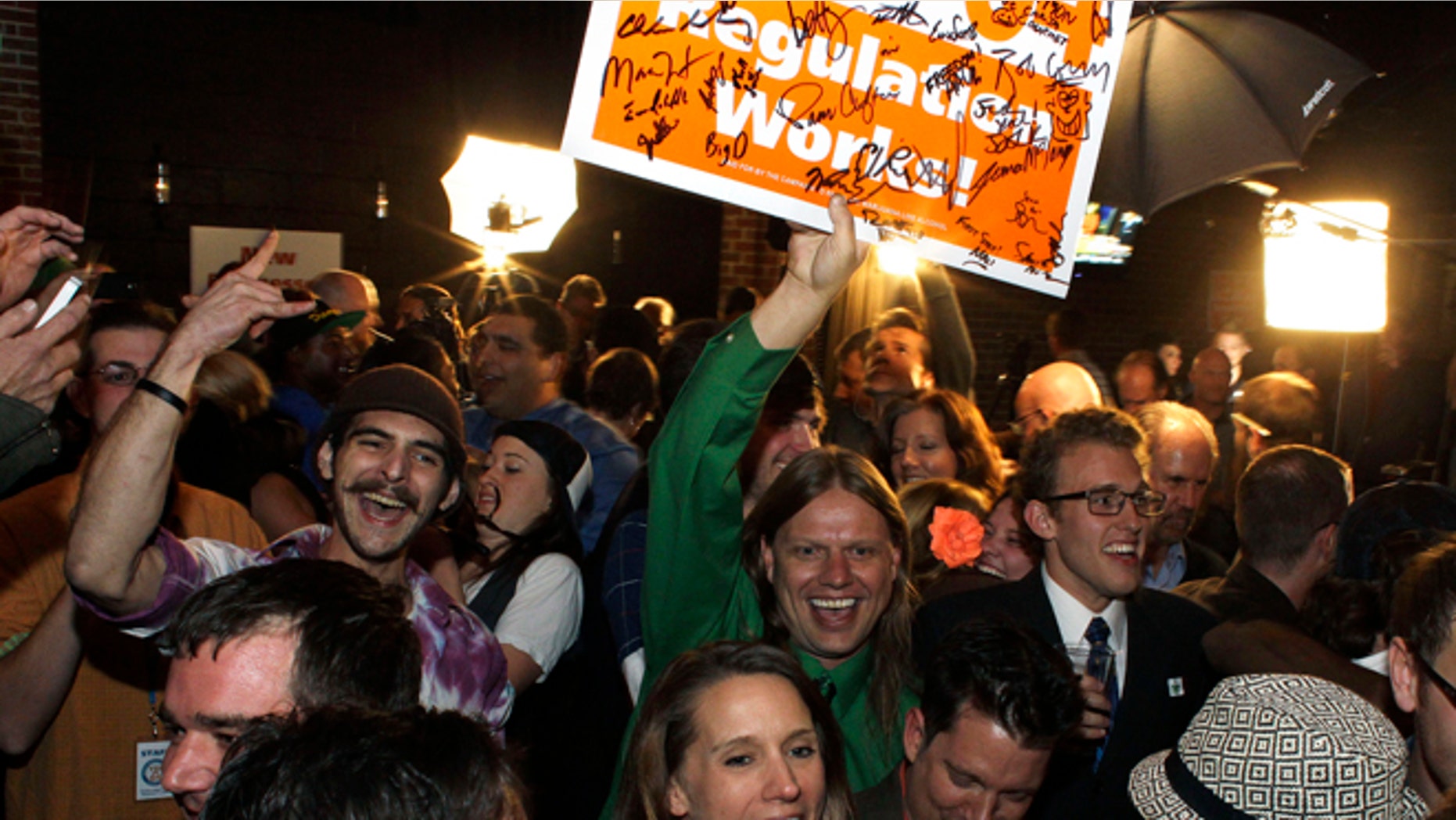 Nov. 6, 2012: People attending an Amendment 64 watch party in a bar celebrate after a local television station announced the marijuana amendment's passage, in Denver, Colo.