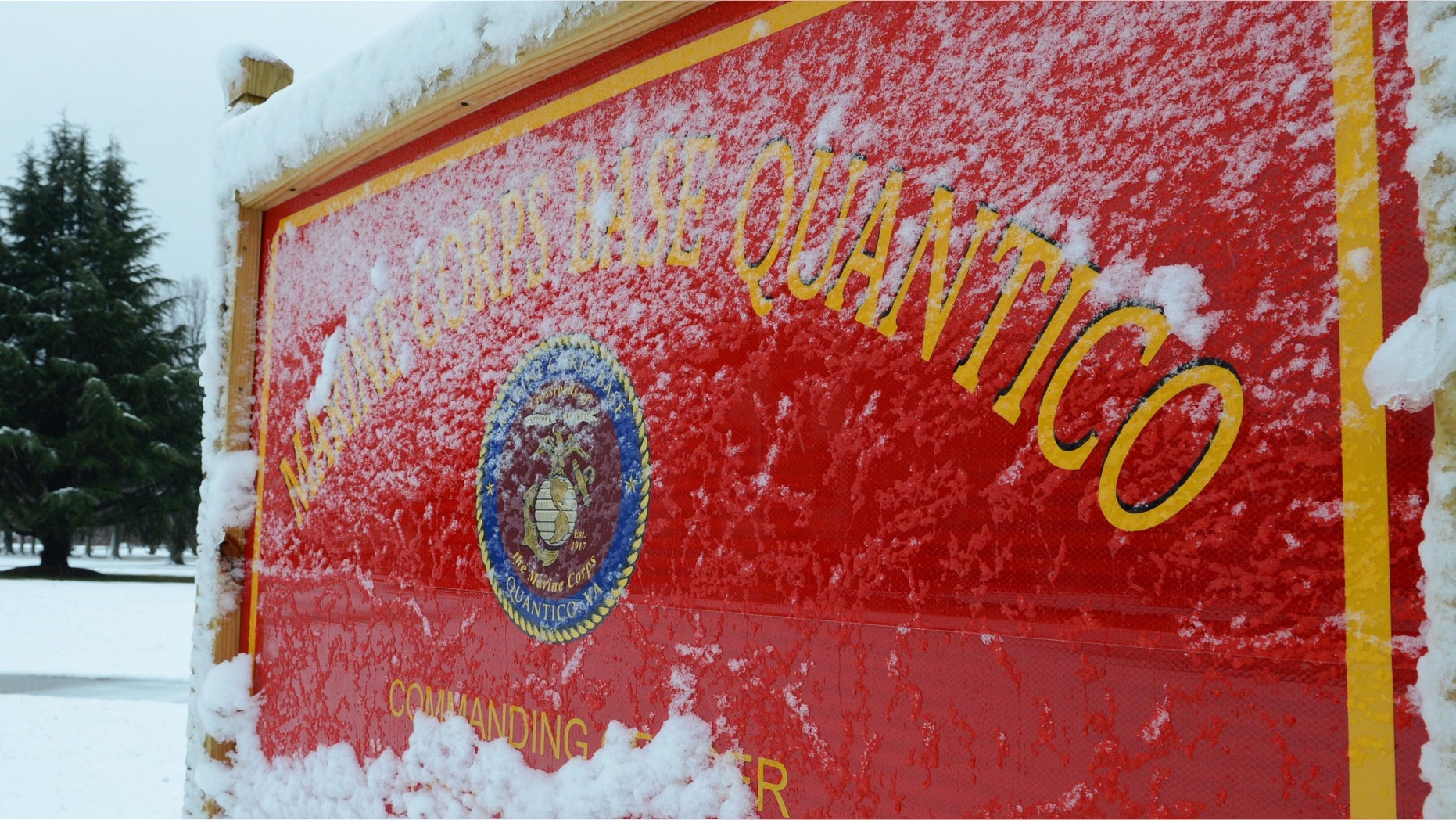This image provided by the U.S. Marine Corps shows snow covering one of Marine Corps Base Quanticoâs many signs Wednesday March 6, 2013. One person was dead after a shooting at Marine Base Quantico and authorities were in a standoff early Friday March 22, 2013 with the suspect, who had barricaded himself in barracks, base spokesman Lt. Agustin Solivan said. Solivan said they believe the suspect, whose name wasn't released, is a staff member at the officer candidate school at the base. No information on the victim was immediately released. (AP Photo/US Marine Corps, Cpl. Antwaun L. Jefferson)