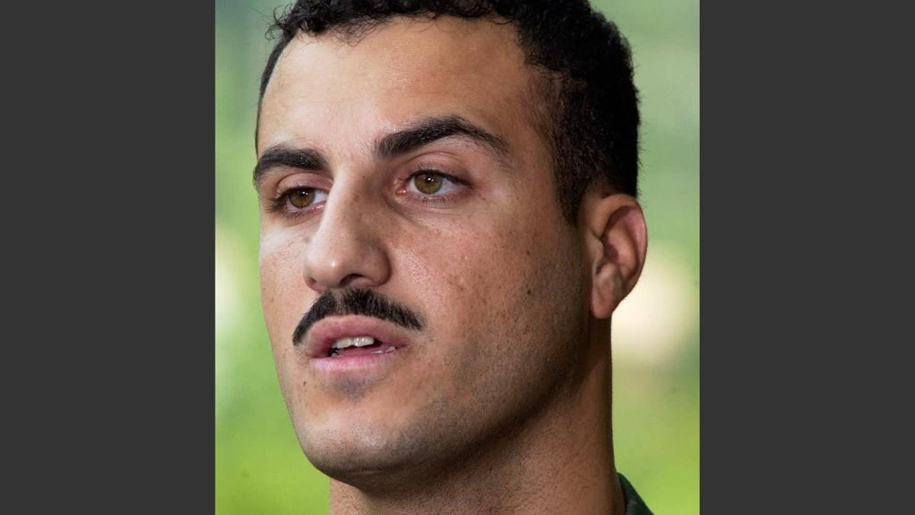 FILE - In this July 19, 2004 file photo, Marine Cpl. Wassef Ali Hassoun makes a statement to the media outside Quantico Marine Base in Quantico, Va. Marine spokesman Lt. Col. Cliff Gilmore said Wednesday, Nov. 19, 2014, that a judge decided last week to deny Cpl. Hassoun's request for another Article 32 hearing, the military equivalent of a grand jury hearing. Gilmore said Hassoun's general court-martial is scheduled to begin at Camp Lejeune on Dec. 8 before the judge, Marine Maj. Nicholas Martz. (AP Photo/Steve Helber, File)